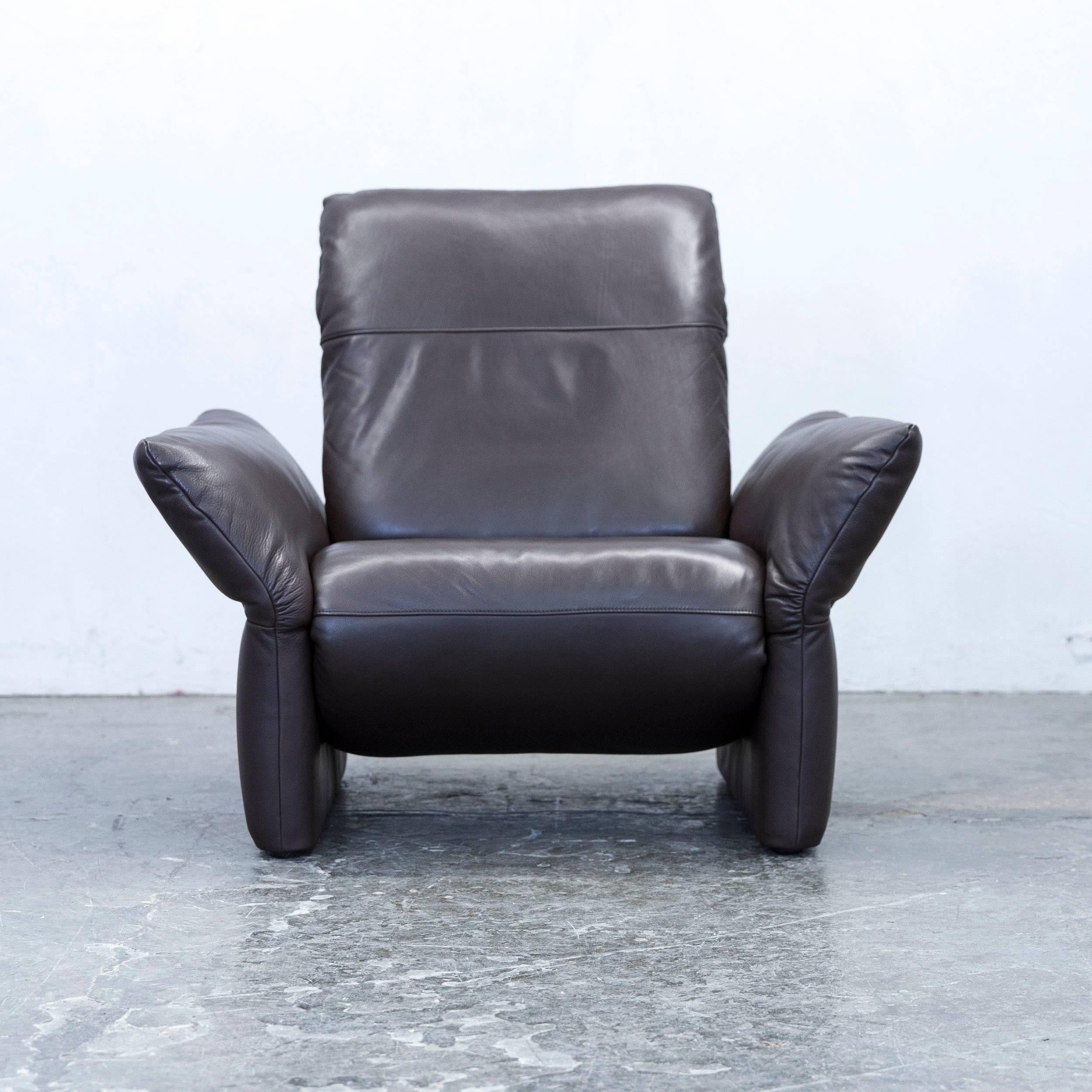 Brown colored Koinor Elena designer leather armchair, in a minimalistic and modern design, made for pure comfort.