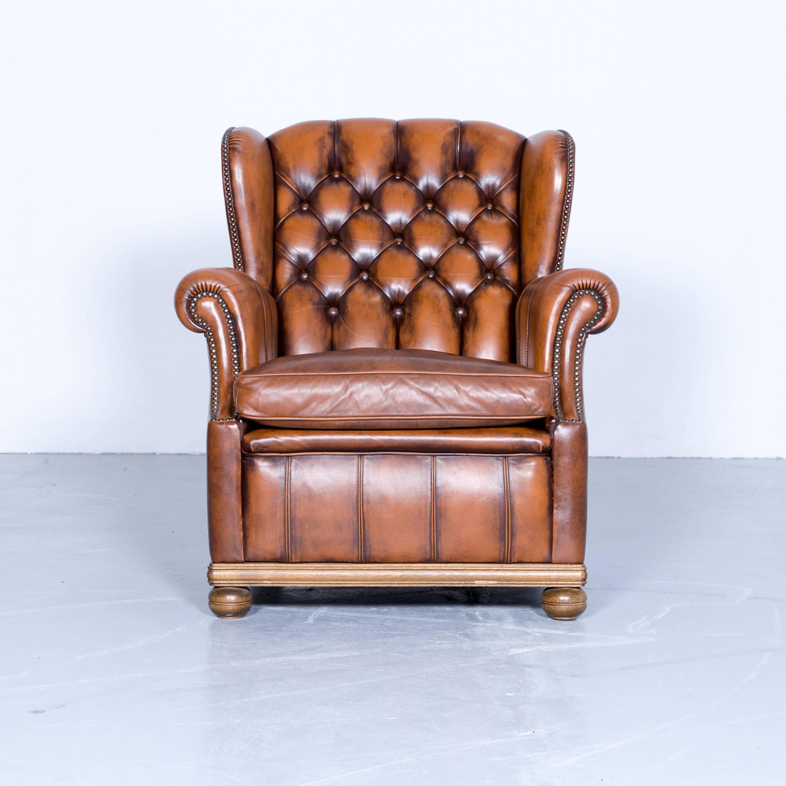 Brown colored Chesterfield leather armchair, in a vintage and elegant design, made for pure comfort and style.