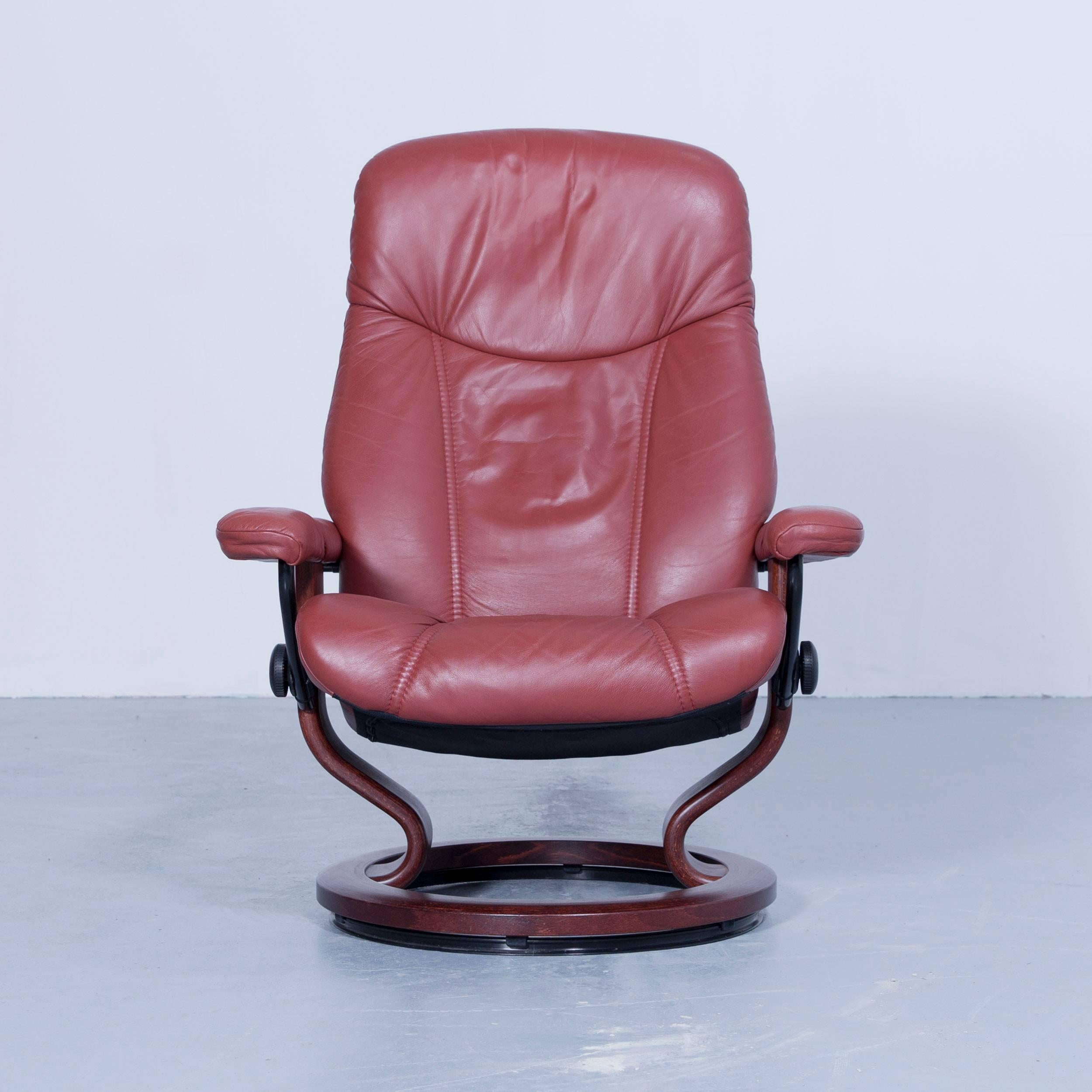 Red brown colored original Stressless Consul M designer leather Swivel chair in a minimalistic and modern design, with convenient functions, made for pure comfort and flexibility.