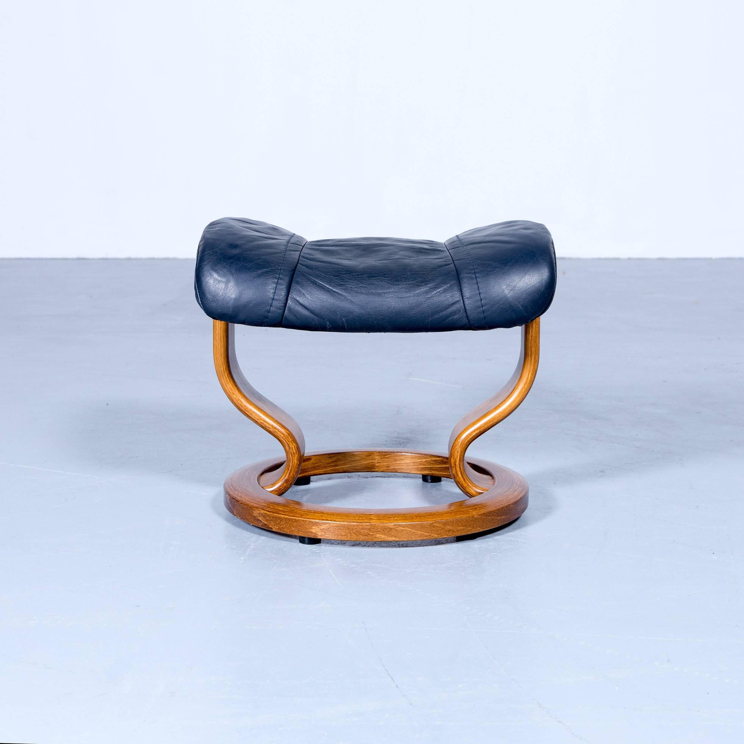 Ekornes Stressless wing footstool leather dark blue modern footrest in a minimalistic and modern design, with convenient functions, made for pure comfort and flexibility.