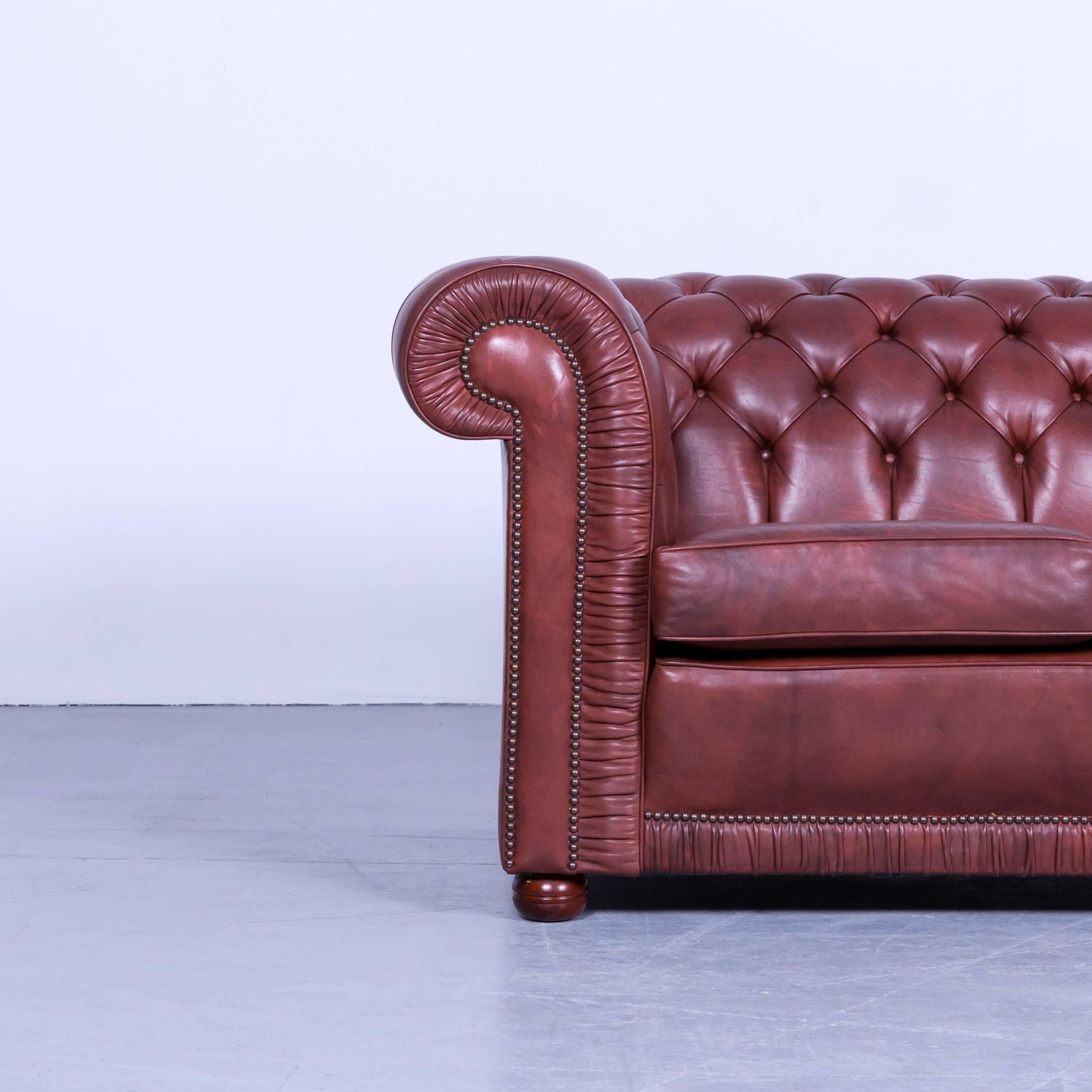 Chesterfield two-seat sofa red brown vintage retro handmade rivets.