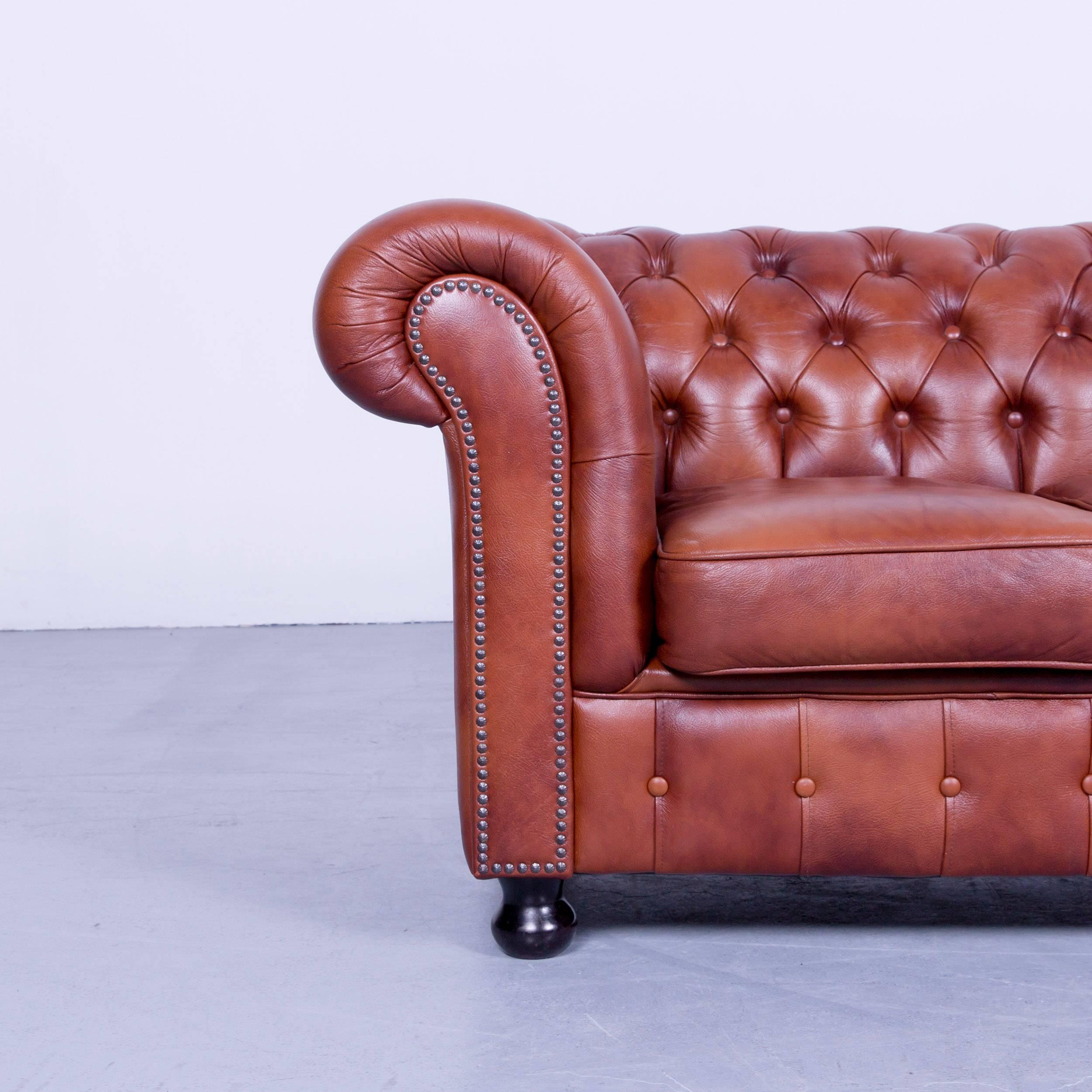 Chesterfield three-seat sofa brown orange cognac vintage retro handmade rivets.