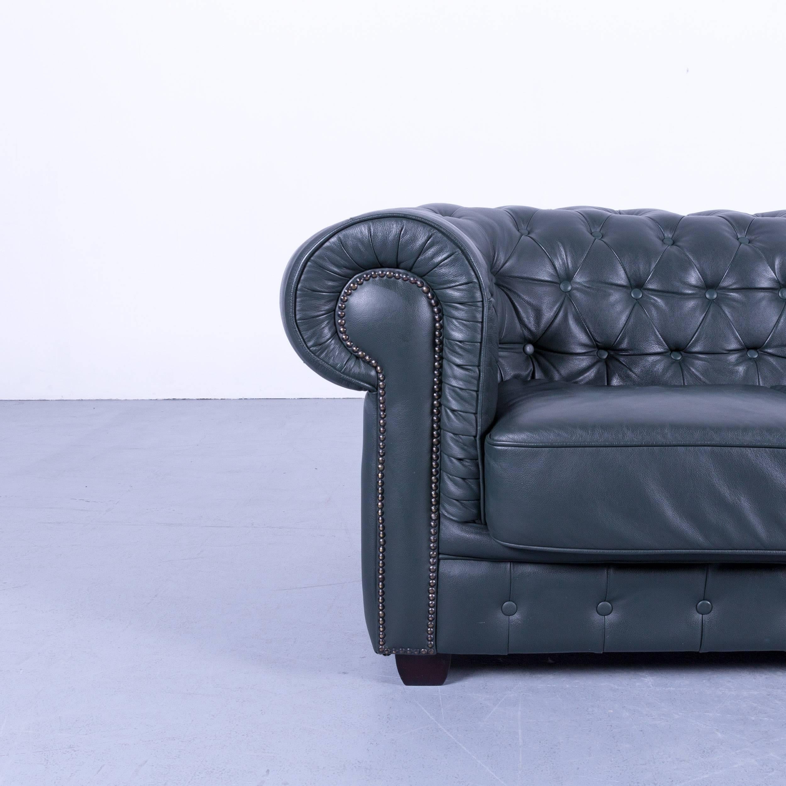 Chesterfield sofa dark green two-seat vintage retro couch rivets UK, made for pure comfort and elegance.