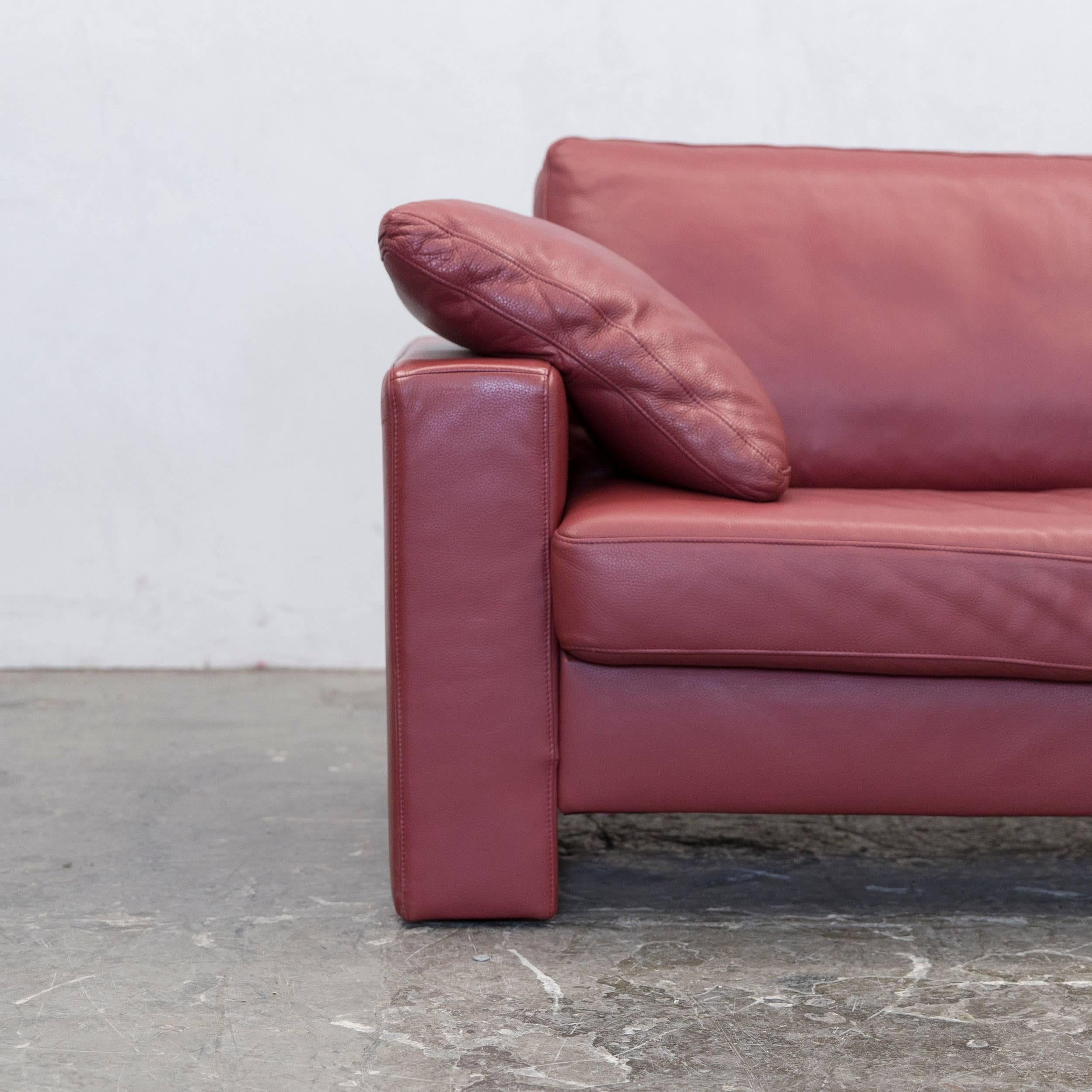 Red colored original Ewald Schillig designer two-seat couch, in a minimalistic and modern design, made for pure comfort.