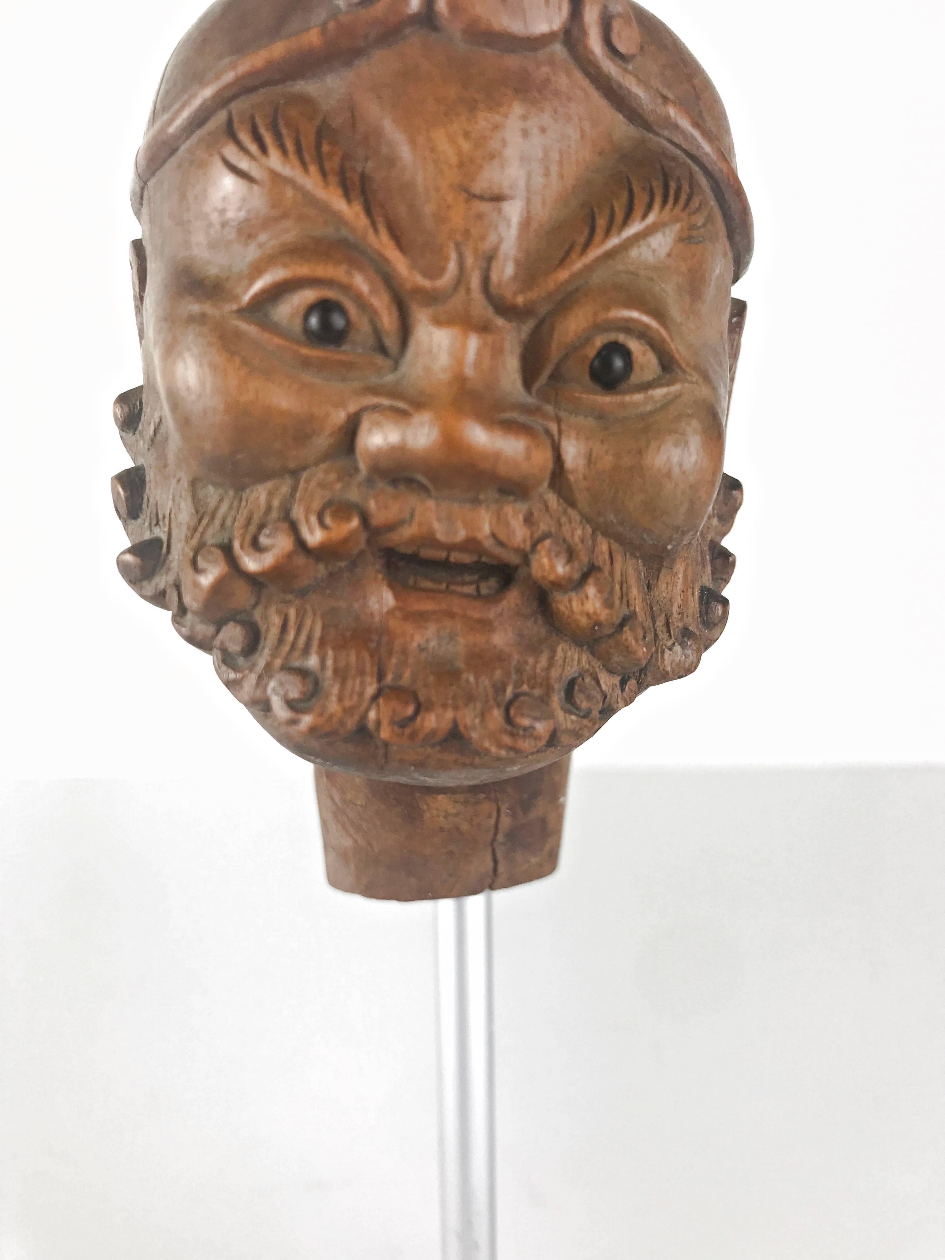 Fine carved Chinese head from a puppet in the form of a Buddhist arhatt, mounted on a wooden base, 19th century.
Size with base is 7.5 inch (19 cm) high.