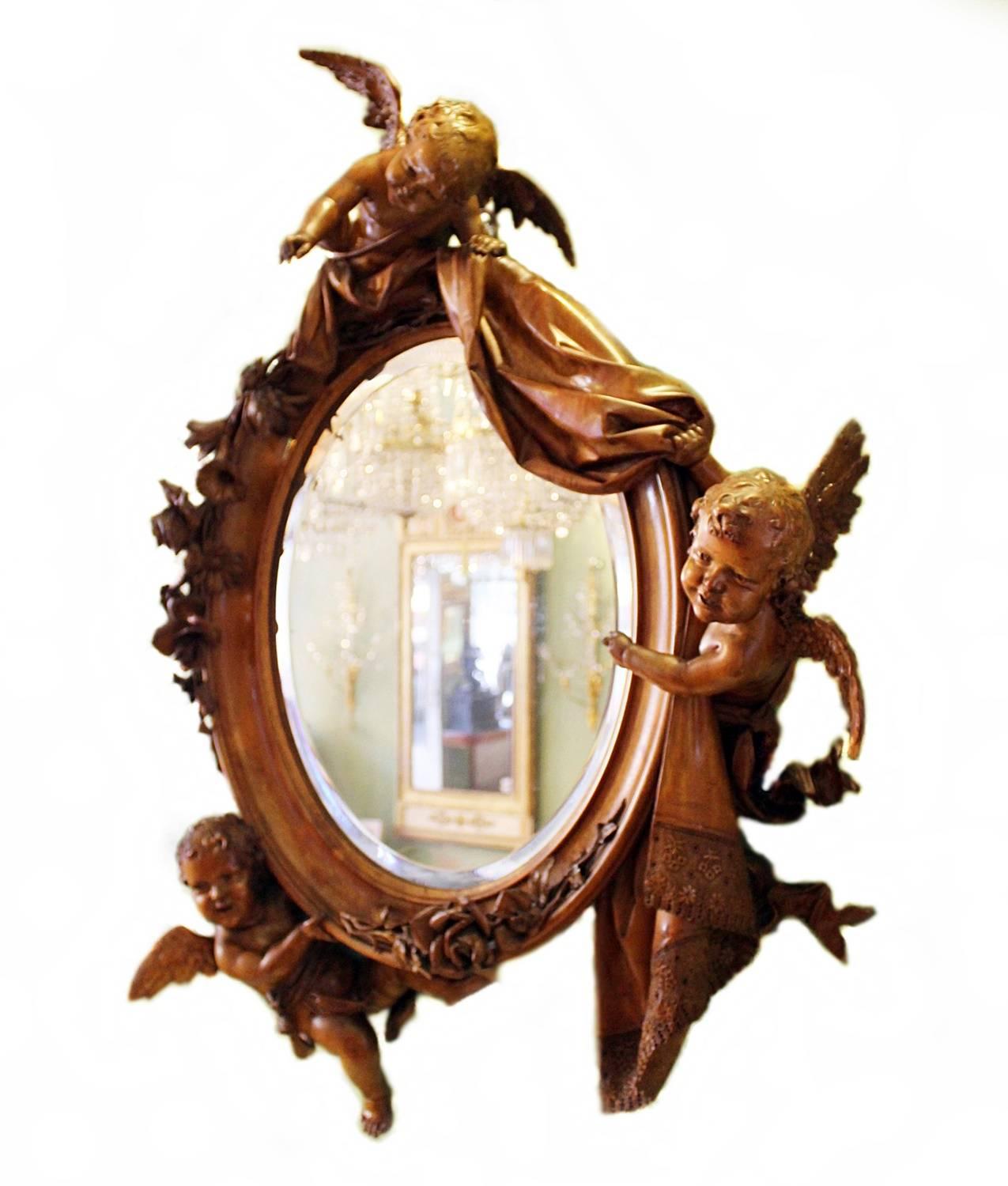 A highly carved and richly ornamental Italian mirror of superb quality. Carved in walnut wood with the original mirror glass. Probably made in Venice, Italy by Valentino Panciera Besarel (Venice, 1829-1902).