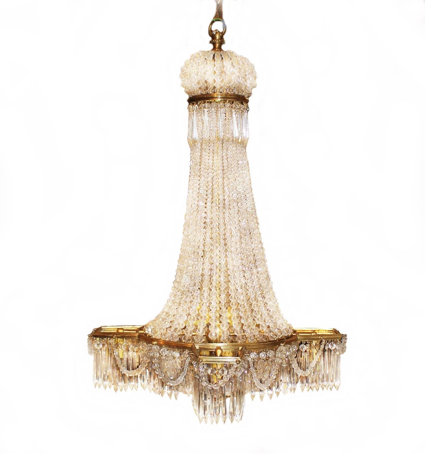 A beautiful and different chandelier made in France, circa 1900. The chandelier is elegant with many smaller prisms and an unusual frame in form and shape.