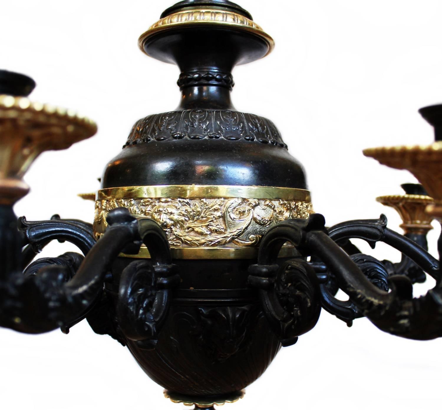 A monumental and robust patinated and gilt-bronze hanging lamp from France made circa 1830. The details of the casting is of a very high quality.
