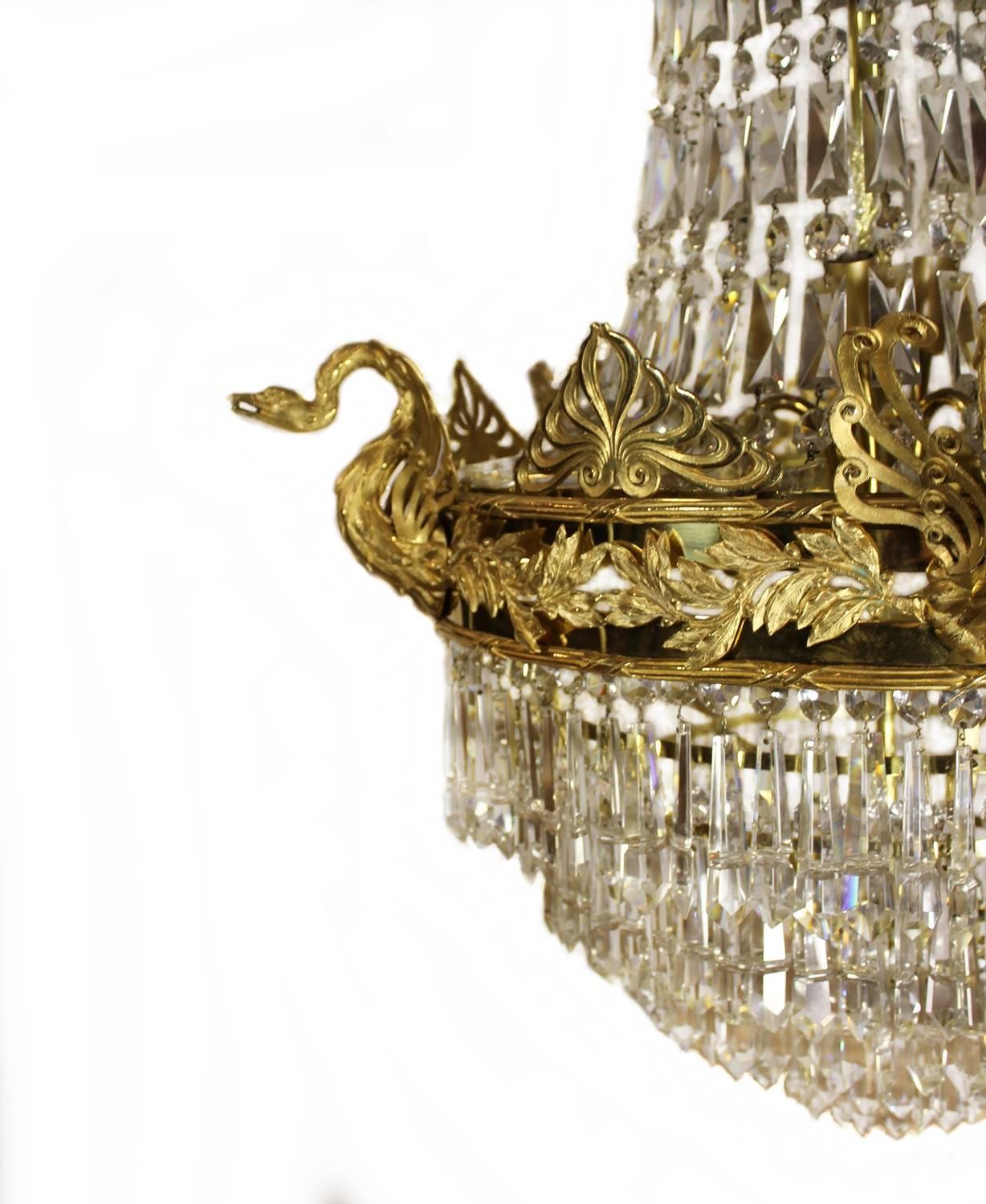 A truly beautiful and elegant basket chandelier from the second half of the 19th century. Probably made in France. The bronze frame is of the highest quality, rich with ornaments and impressive swans. The casts are superbly made and gilded to a very