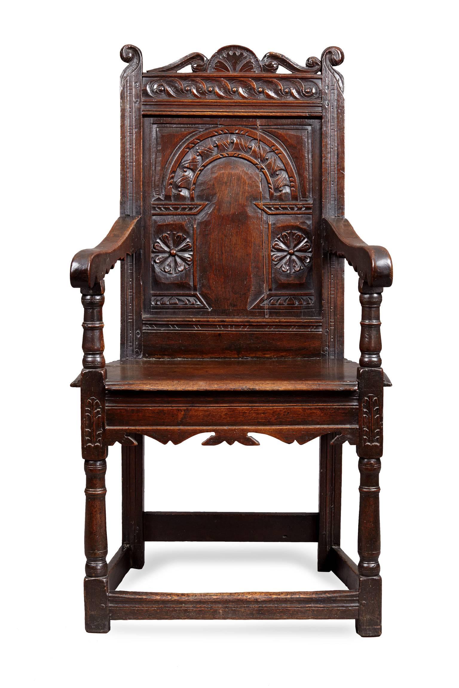 Charles I oak armchair, Gloucestershire

The perforated scroll carved cresting flanked by reverse scroll carved uprights above an 'S' scroll rail and deeply carved arcaded back panel with floral carved uprights. The bold silhouette arms on turned
