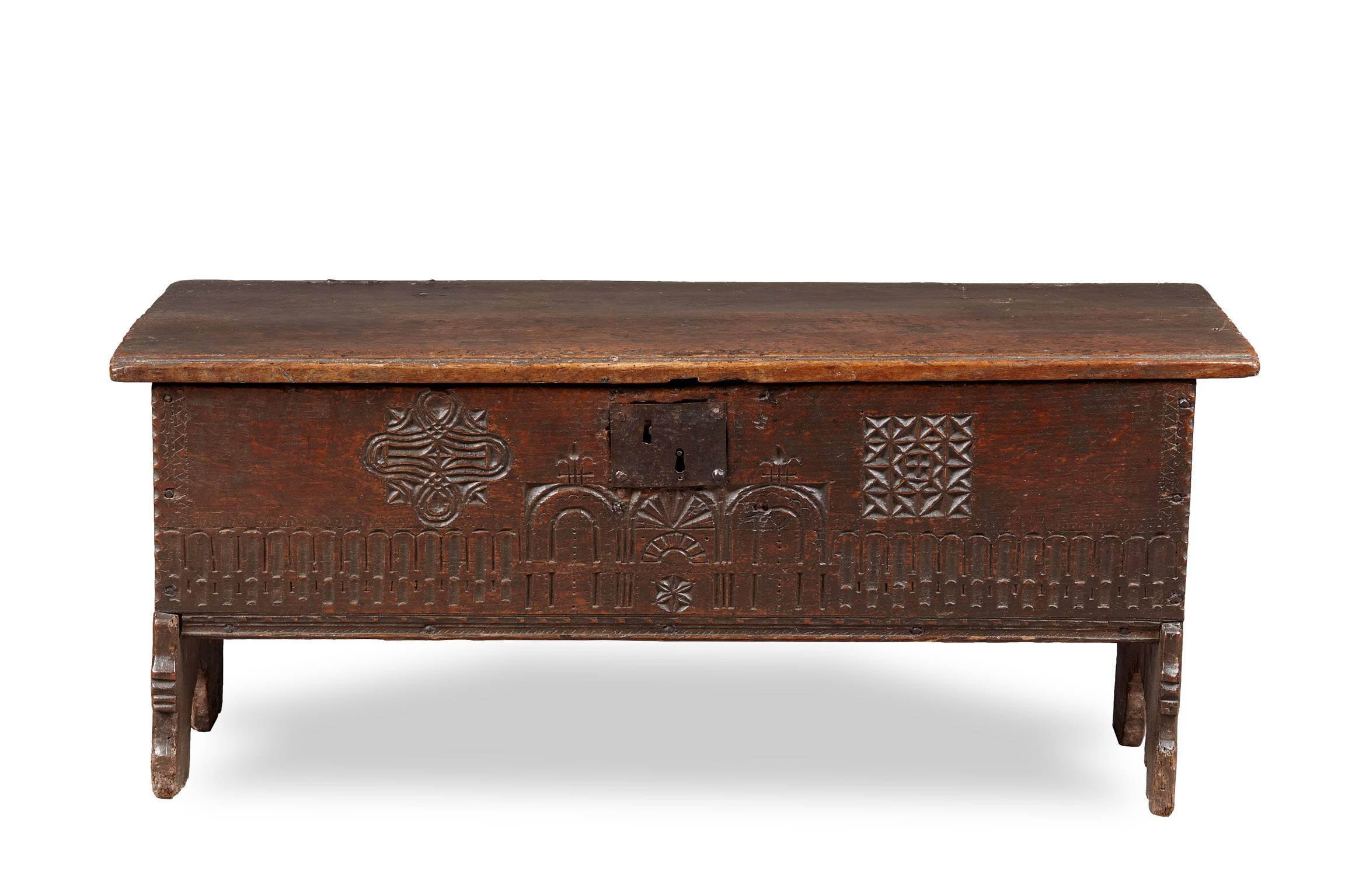 Rare and unusual Mid Elizabethan oak boarded low chest.

The six plank boarded chest with lightly inscribed and moulded lid above a front panel with a combination of chip carved Gothic and Celtic interlace patterns flanking lunette and trefoil