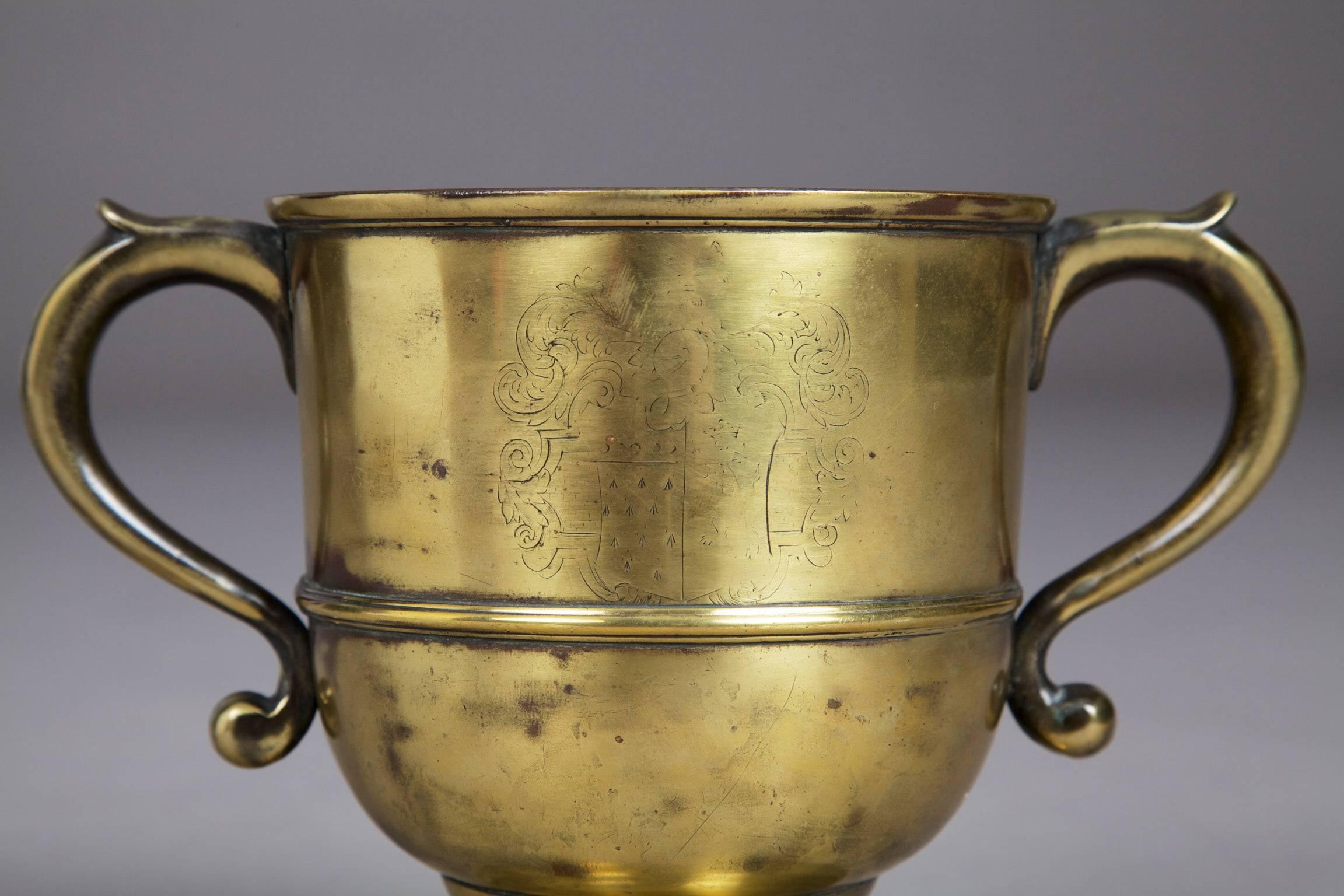 Early 18th century English brass loving cup

The twin handled loving cup engraved with the Arms of the Westons of Sutton Place, Surrey. The cup was originally silver plated, now cleaned, still with traces of original silvering. 

Sutton Place,