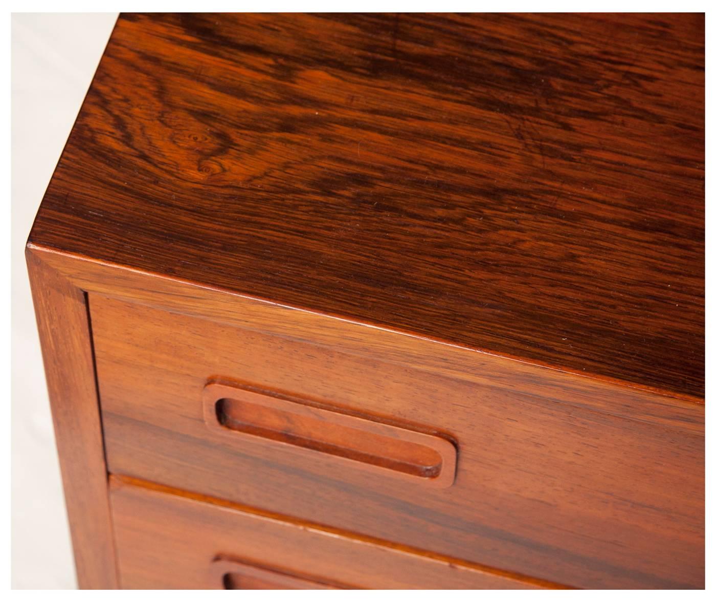Four-drawer rosewood sideboard with stunning grain. Stamped with makers mark. Made in Denmark.