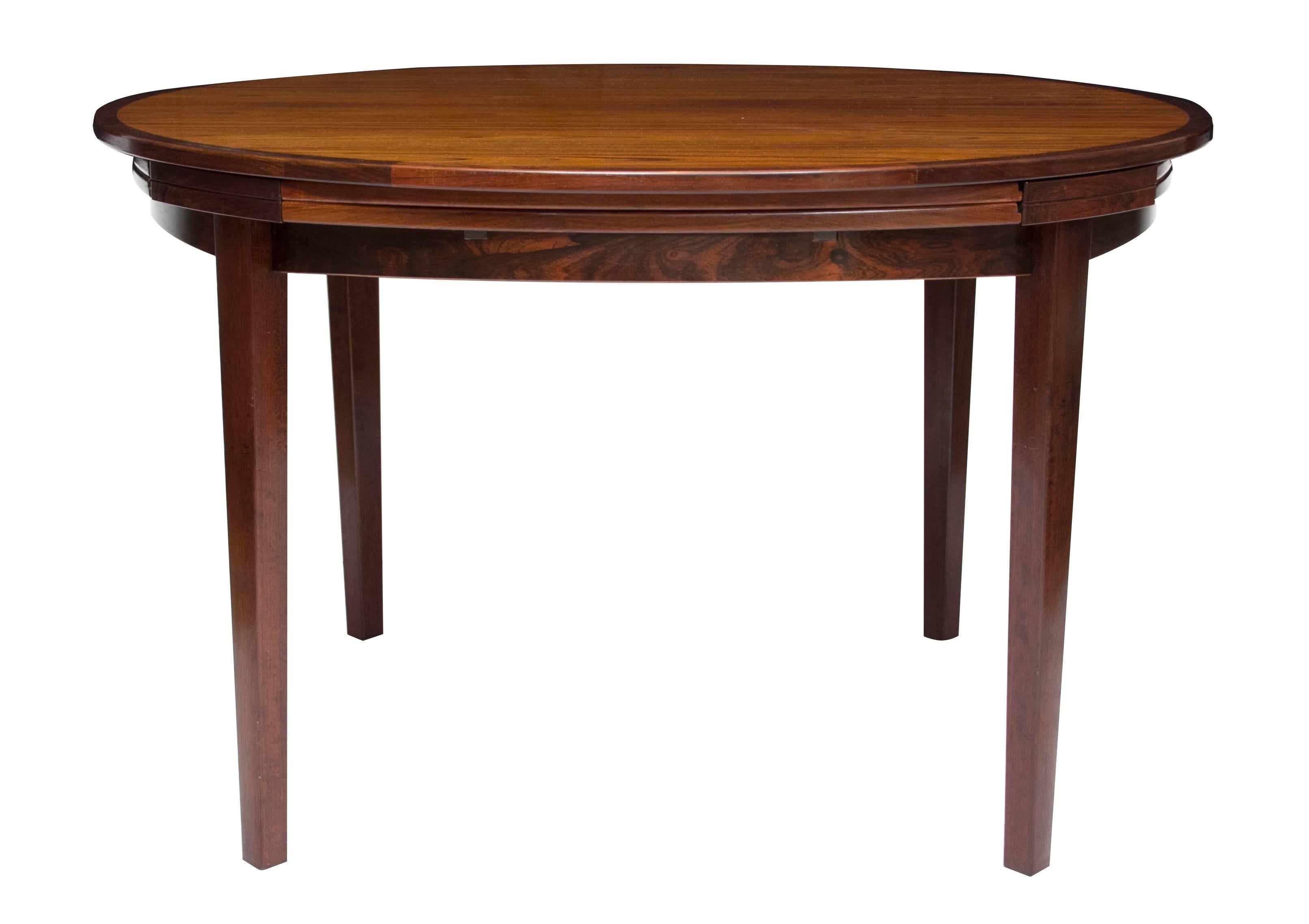 Rosewood circular extending dining table. Measuring 120 cm diameter extending to 176 cm.