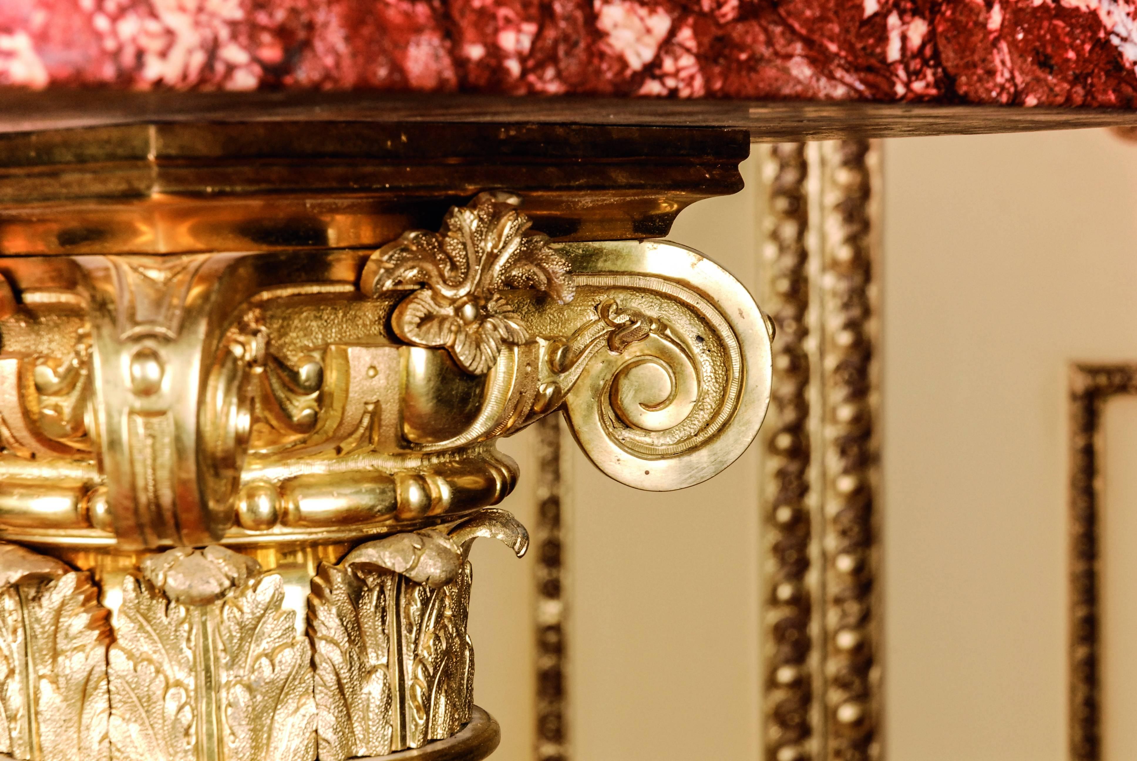 Bordeaux red marble with gray-white grain. Square plinth with balustrade shaped column base with decorated acanthus capitell. The high-quality, chased bronze are distinctive and of exceptionally good quality. Wide, stepped square top plate. Exactly