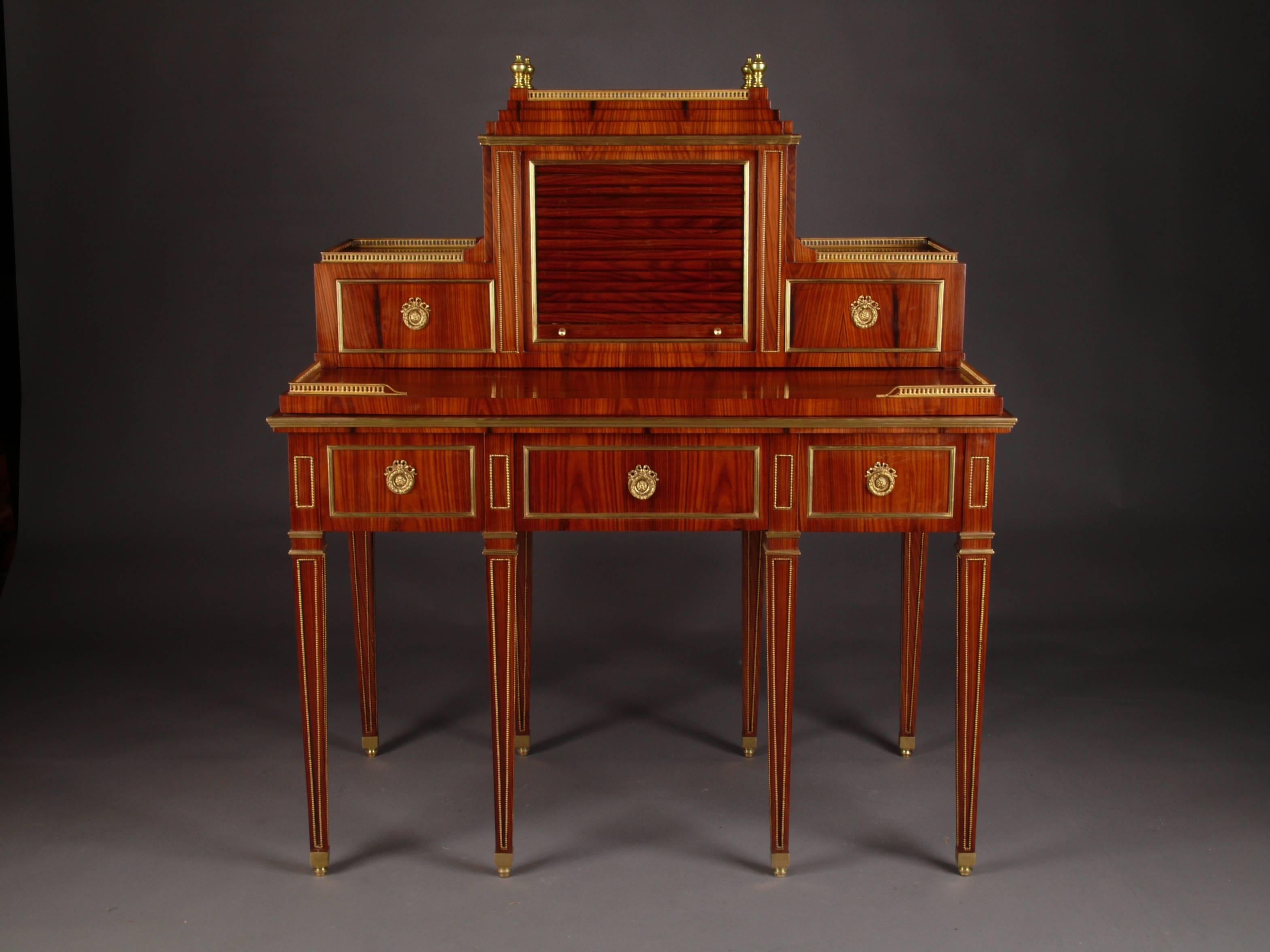 Palisander on solid pinewood. Border table on the front side one real and two false drawers, on the side a secret drawer over conical pointed, with brass beaded legs. The drawer fronts in brass profile. A flush edging gallery in balustrade form. A