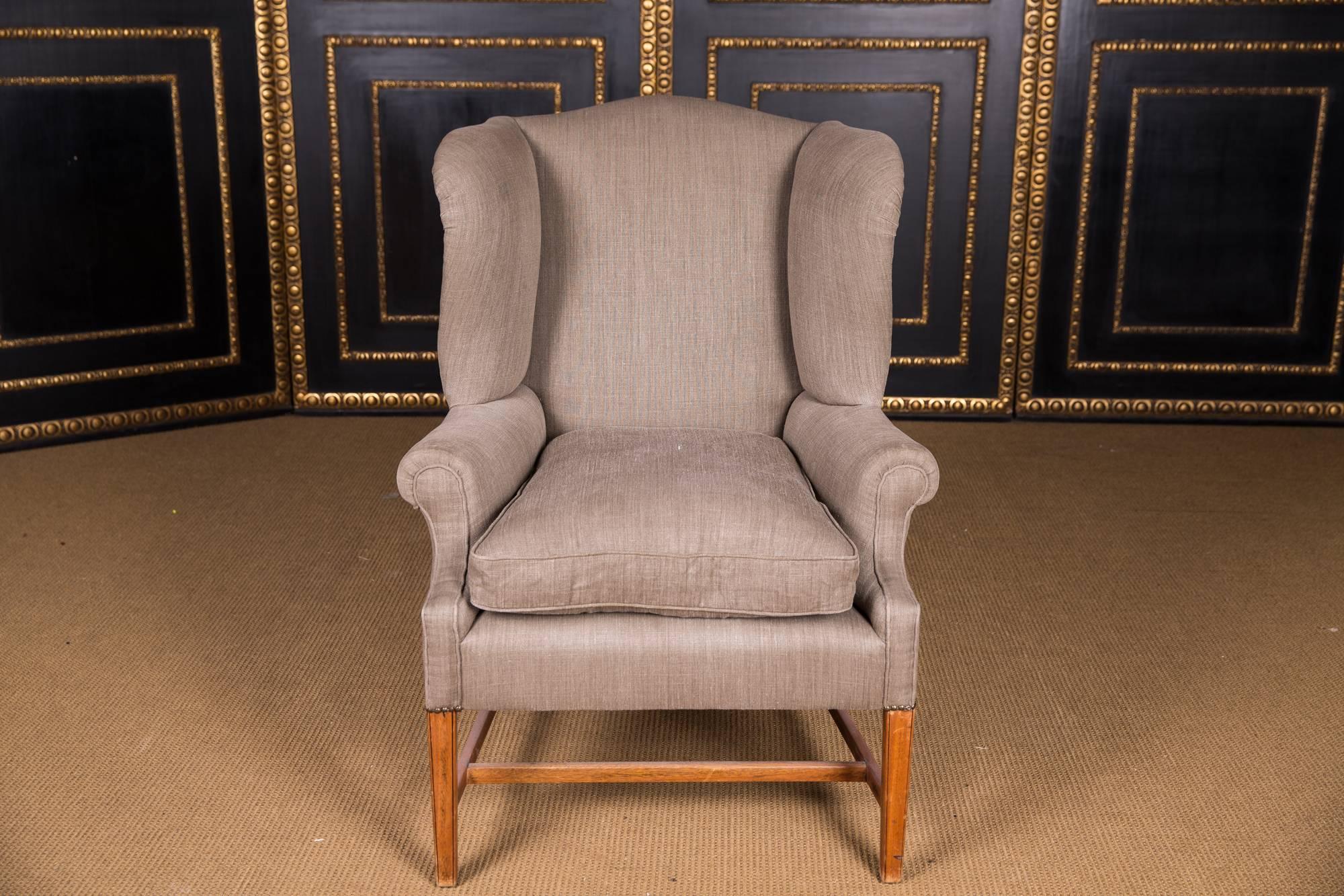 Straight frame on straight legs. Short supports for cambered armrests. High-backed backrest frame. Laterally slightly curved armrests. High quality original Classic upholstery with fine linen fabric.

The fabric cover is as new. A timeless