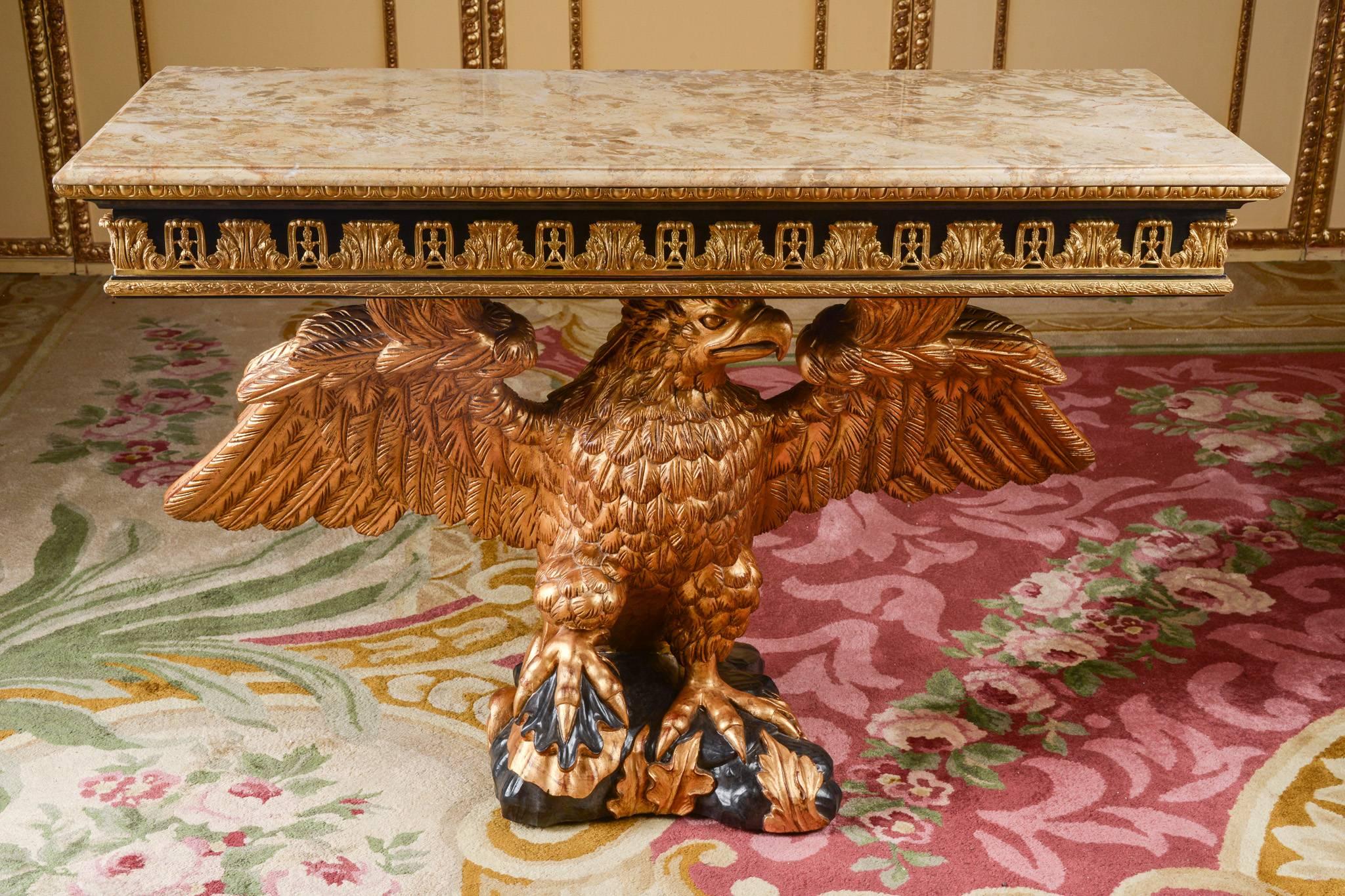 A console table of the Régence epoch. Monumental, hand-carved eagle made of solid beech. Partially black and gold-painted, standing on a plate. Rectangular marble top slab above frame. Fries made from acanthus leaf fittings. The fittings are