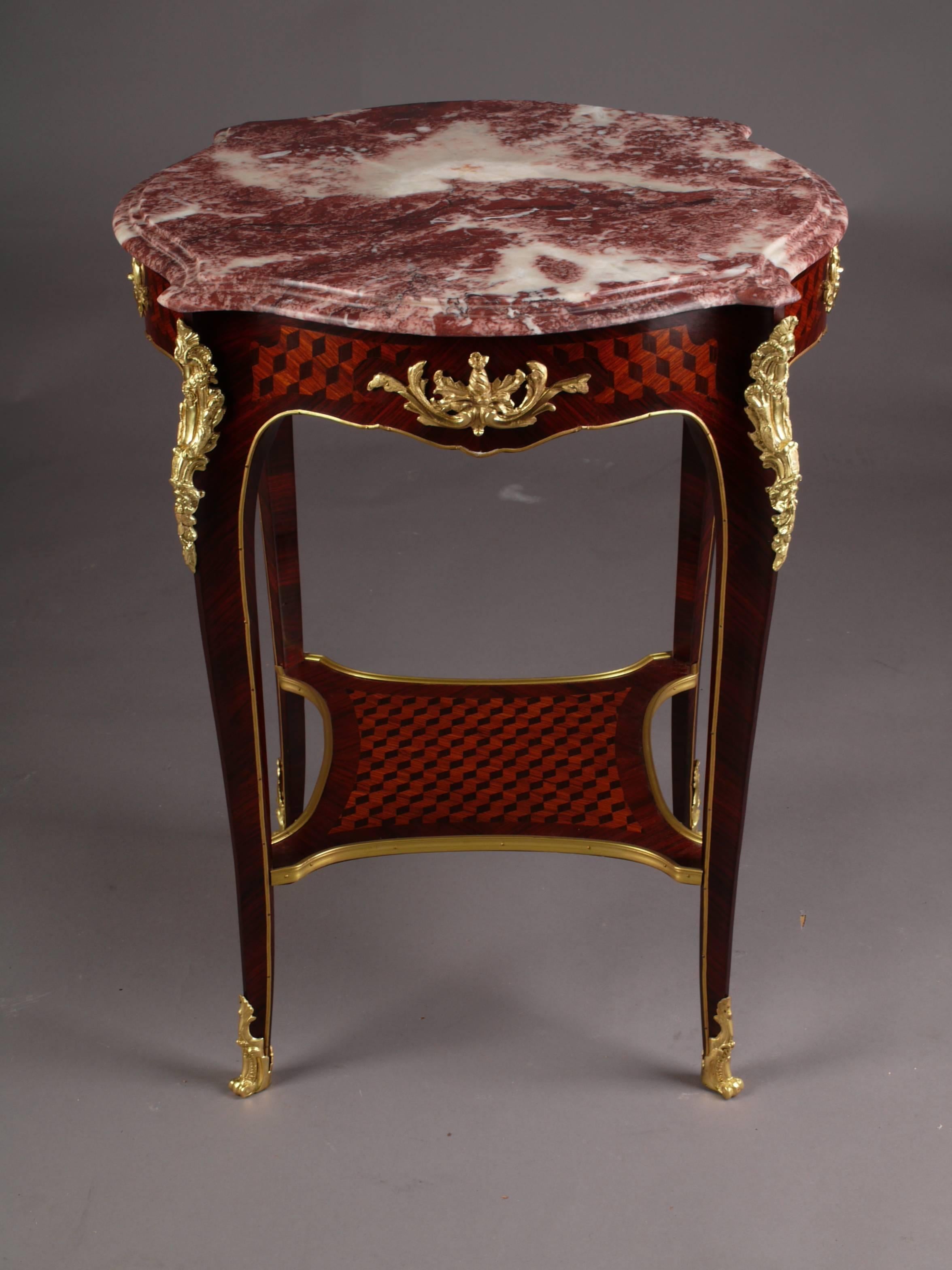 Rosewood on solid beech, slightly convex and concave-curved, corpus, flanked by extended corner irons on high, elegantly curved legs, connected below by braided intermediate plate, bound with bronze fittings in sabots. Fillings with a plastic