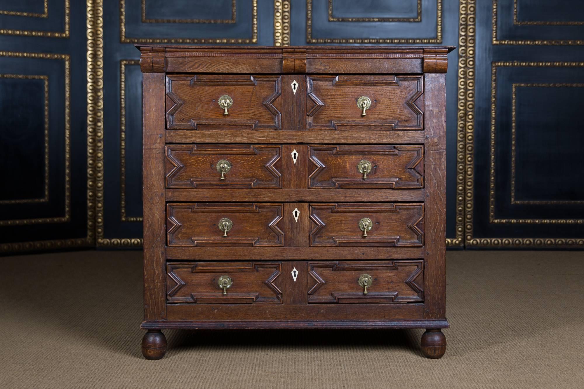 Solid oak. Straight, profile-framed body on round feet. In the front four wide drawers. Slightly overhanging cover plate.

Chest of drawers from the 17th century are extremely rare and difficult to find.

Excellent warm patina aged over decades.