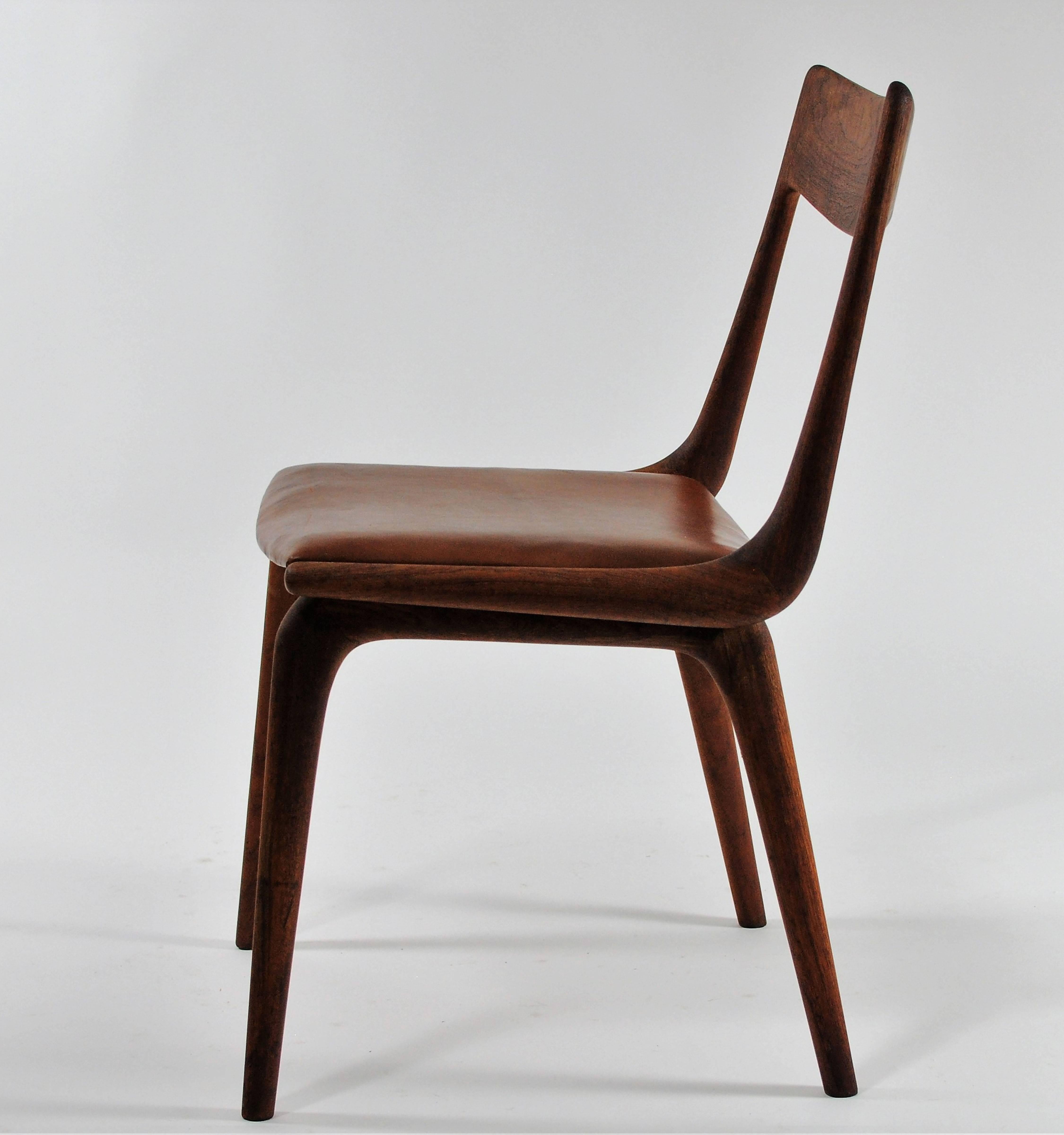 Danish boomerang dining chair in teak by Erik Christiansen for Slagelse Møbelfabrik

The frames of the chair has been refinished and seat is upholstered with soft brown high quality anilin leather from Sorensen leather. 

