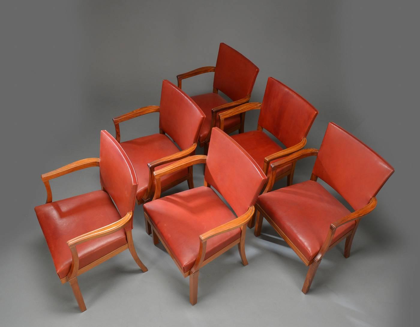 This set of six armchairs in mahogany, walnut and leather were made by Rud. Rasmussen in 1935. According to Rud Rasmussen, the chairs are one of several variants of Kaare Klint's Barcelona chair, made in small numbers by Rud Rasmussen in the 1930s.