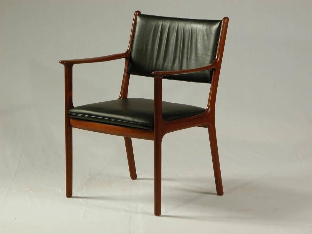 Comfortable Ole Wanscher model PJ 412 mahogany armchair featuring new black leather upholstery on the seat and the original leather upholstery on the backrest.

If you wish to have the chair reupholstered we are happy to make an offer and