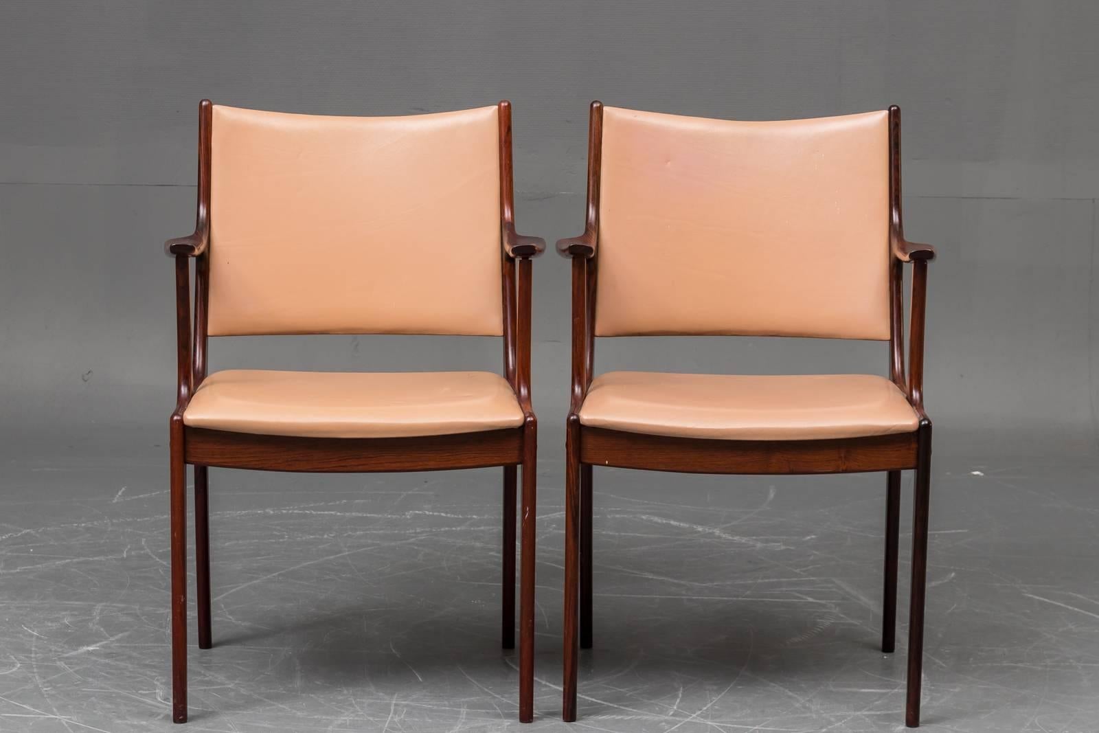 Set of two Danish armchairs in rosewood and brown leather by Johannes Andersen for Uldum Møbelfabrik.

The comfortable well made chairs with Johannes Andersens simple, light and elegant appearance have been refinished by our cabinetmaker and are in