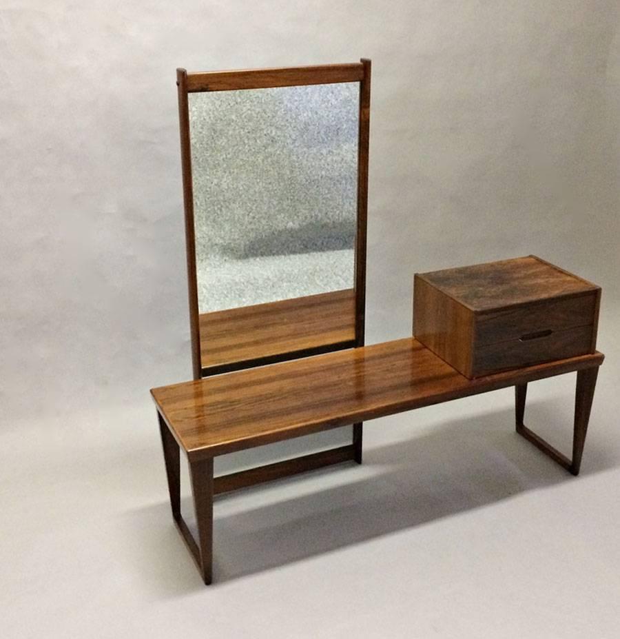 Enterance hall set number 32 in rosewood consisting of bench / table, chest and mirror designed by Kai Kristiansen for Aksel Kjaersgaard in the 1960´s.

The chest can be placed to the left or right of the bench.

The set is stamped by Aksel