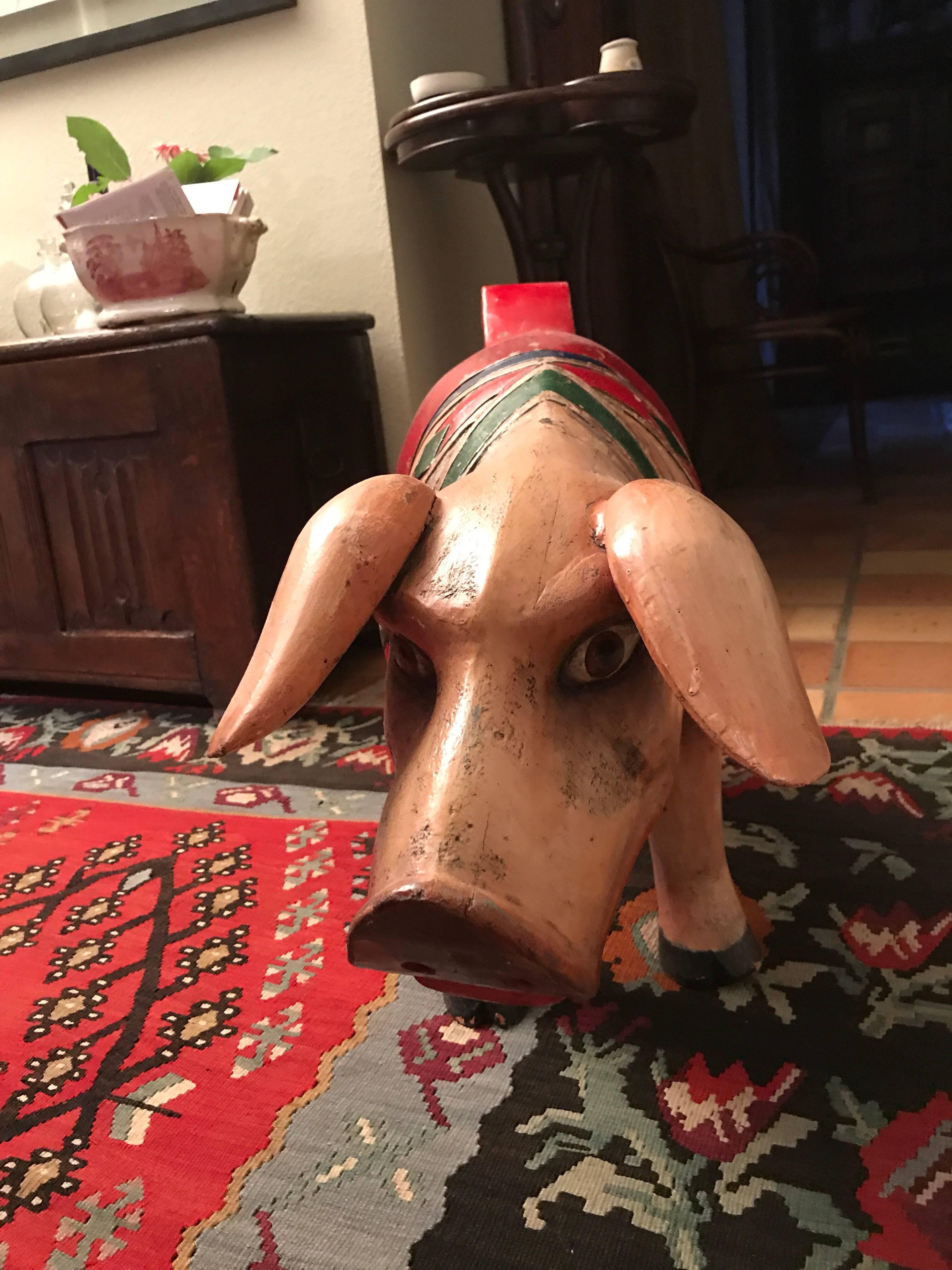 Wooden pig from a fair mill
To sit on for children
Hand-carved
Hand-painted
Unique and rare item from circa 1900. Measures: 90 x 25 x 50 cm very rare
There were normally two pigs on a mill and the second one slightly different can be obtained