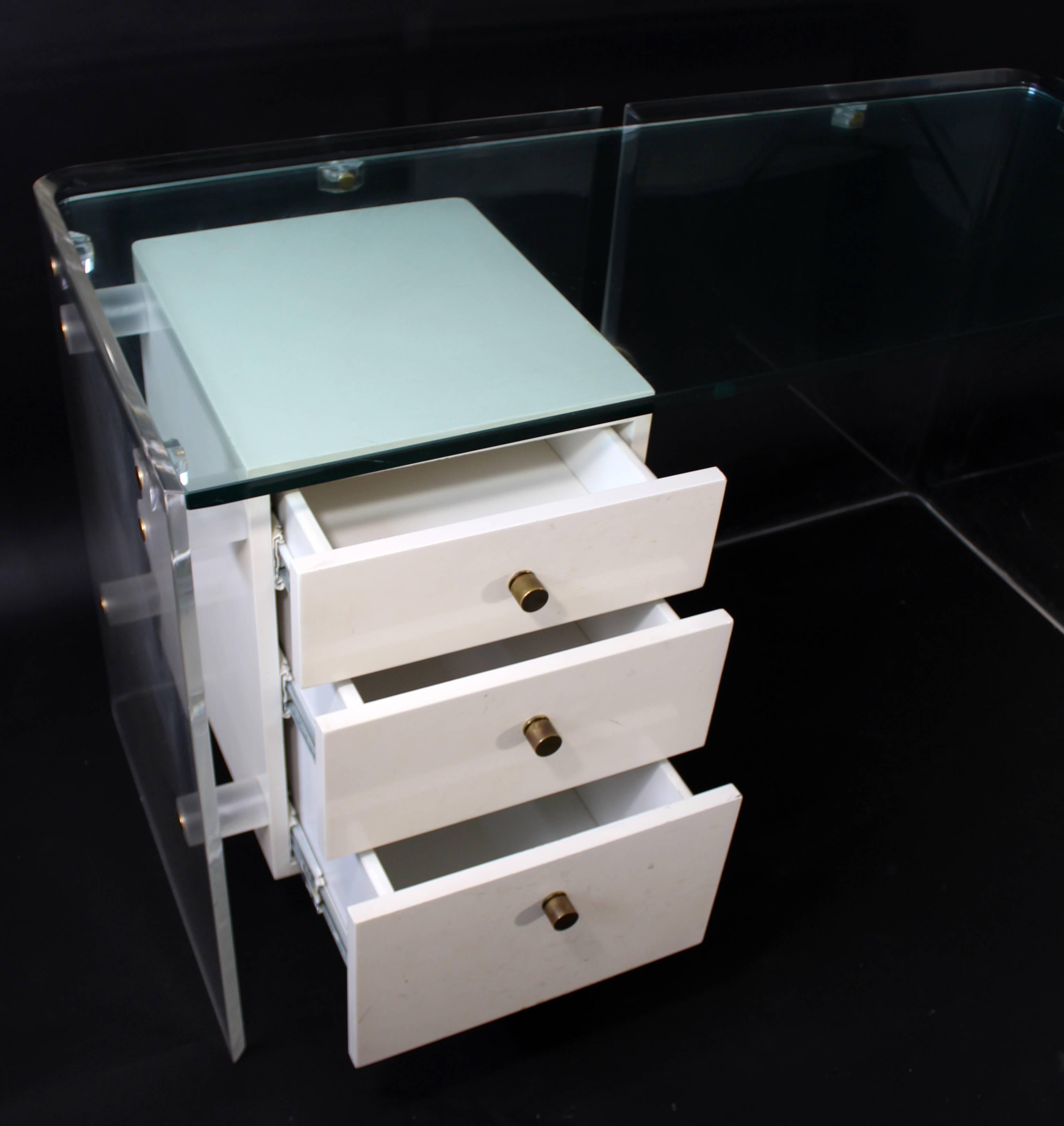 For your consideration is a fabulous and rare 1970s desk, with a Lucite base, a thick glass top and three, white lacquer drawers. Attributed to either Pierre Cardin or Charles Hollis Jones. The dimensions are 55