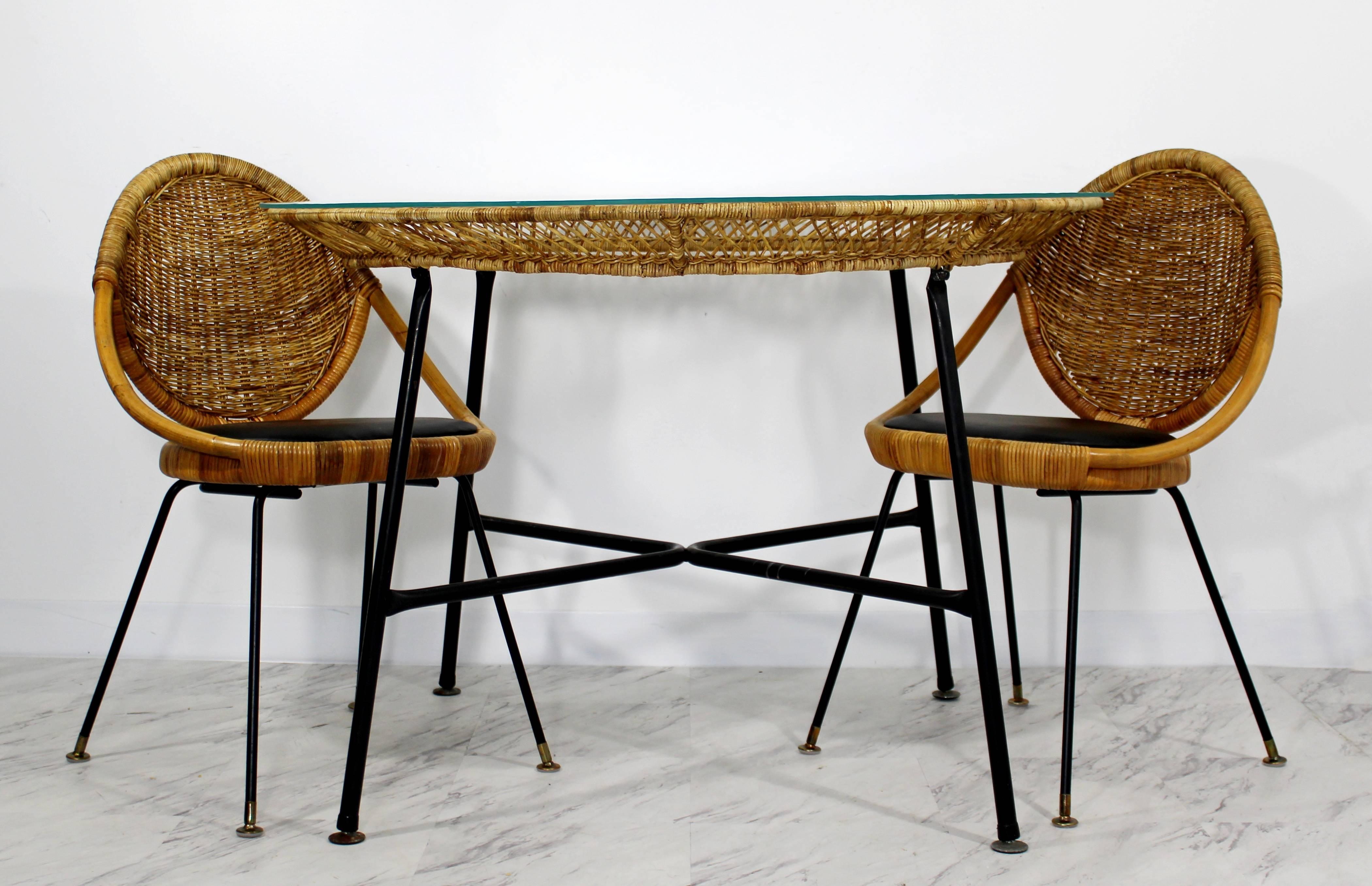 For your consideration is a gorgeous patio set, including a table and two chairs, made of bamboo, rattan and wrought iron by Danny Ho Fong for Tropi-cal. In excellent condition. The dimensions of the table are 43