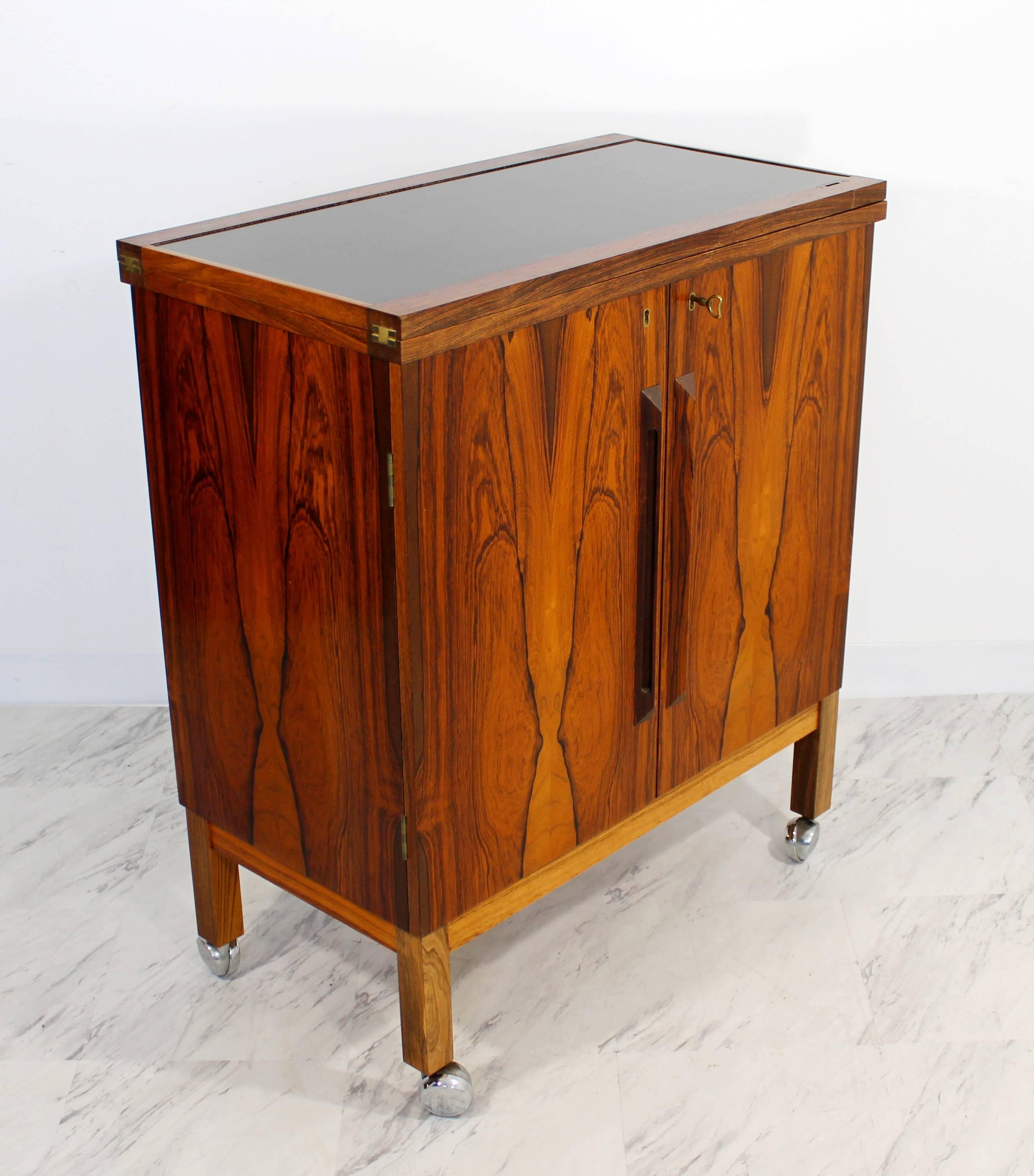 For your consideration is a fabulous, flip-top dry bar, made of rosewood, designed by Torbjørn Afdal for Bruksbo, Norway, circa 1960s. In excellent condition. The dimensions are 30