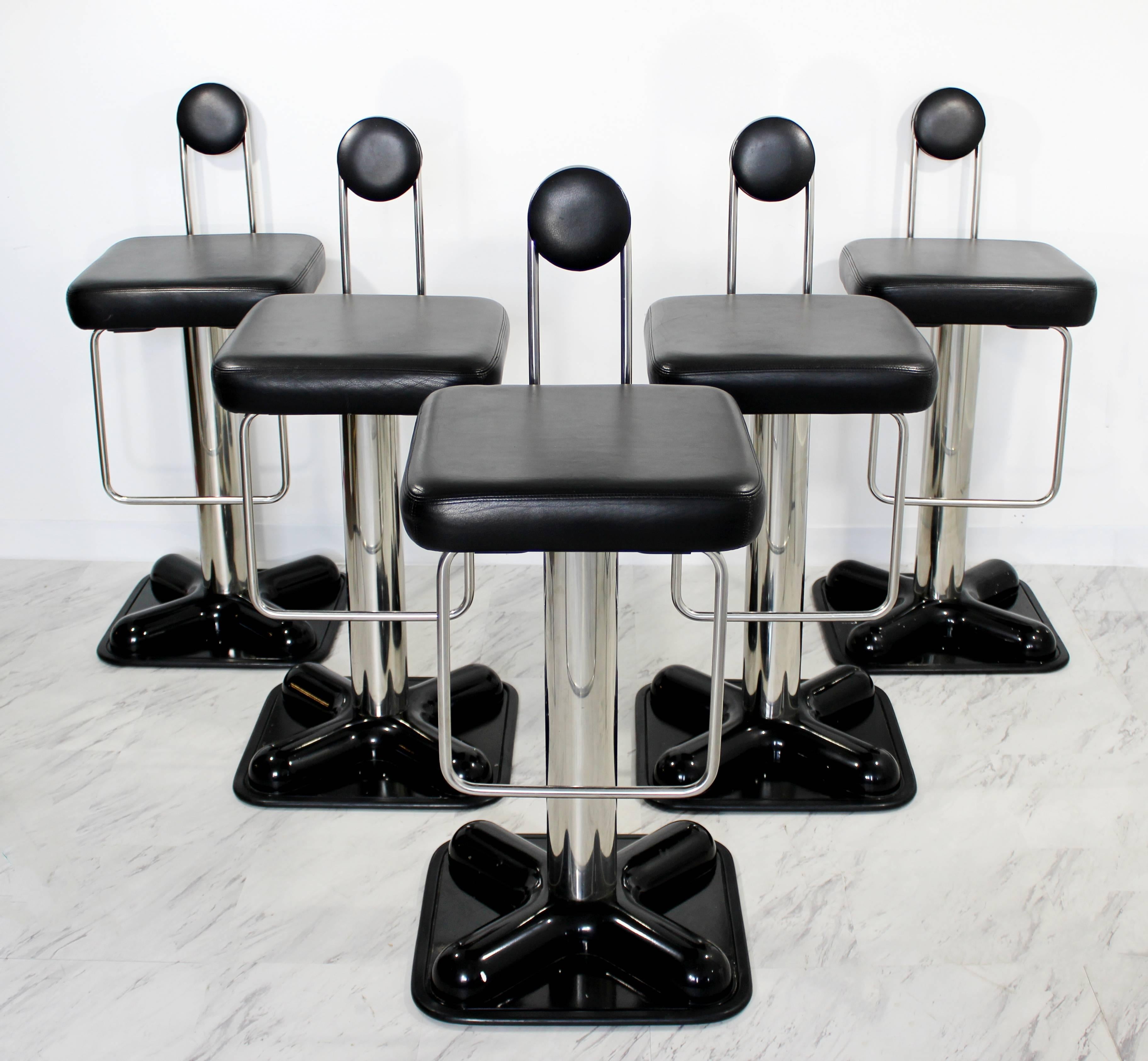 For your consideration is a set of five, incredible bar stools, Birillo model, designed by Joe Colombo for the Italian company Zanotta, in the early 1970s. Pivotable black leather seats sit on chrome stems and black lacquered, plastic bases. Stamped