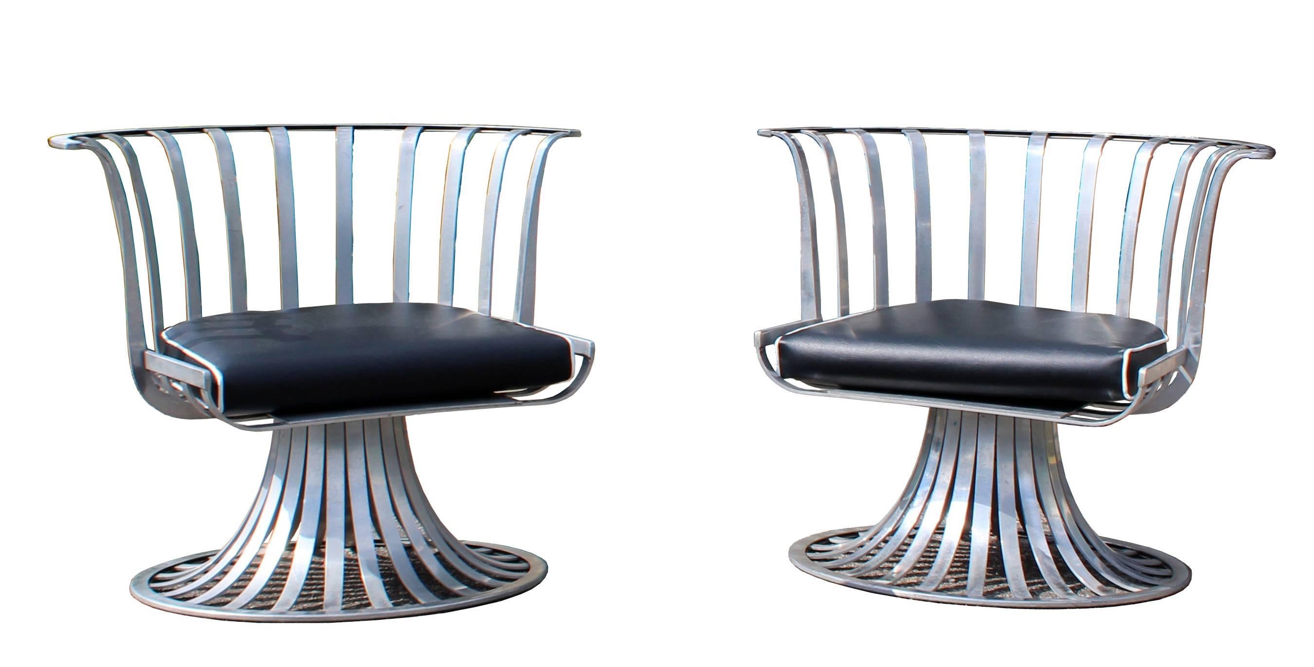For your consideration is a rare and exciting, aluminum spoke patio set, including two chairs and a chaise longue, just back from being professionally reupholstered in black Naugahyde with white piping. Designed by Russell Woodard, circa the 1960s.