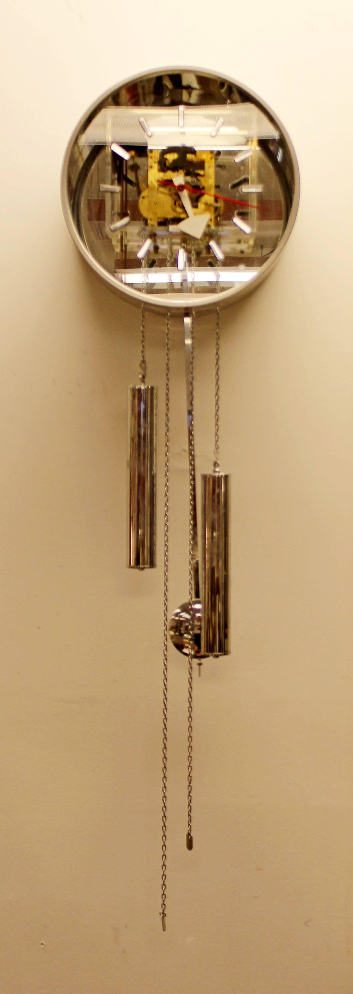 Pendulum wall-mounted clock by George Nelson for Howard Miller made of aluminium, chrome and Lucite. The face of the clock is 12