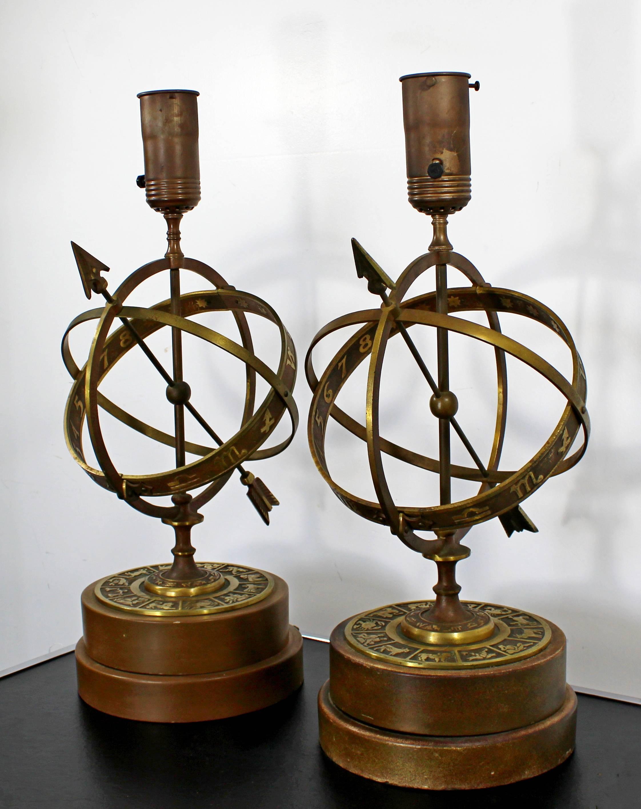 For your consideration is a Classic pair of astrological, armillary sphere table lamps, depicting zodiac signs, by Frederick Cooper, circa 1960s. These beautiful lamps are constructed of copper-plated iron with a solid turned wooden base. In very