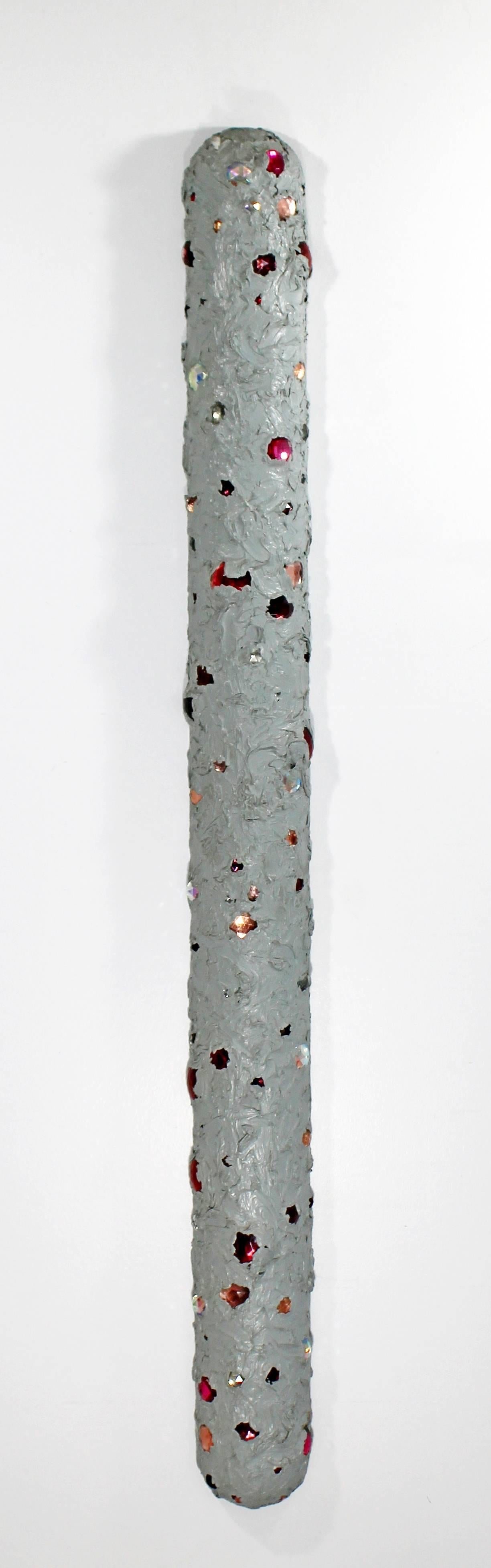 For your consideration is an untitled, hanging wall sculpture, made of grey oil with glass jewels on wood, by John Torreano in 1975. In excellent condition. The dimensions are 4