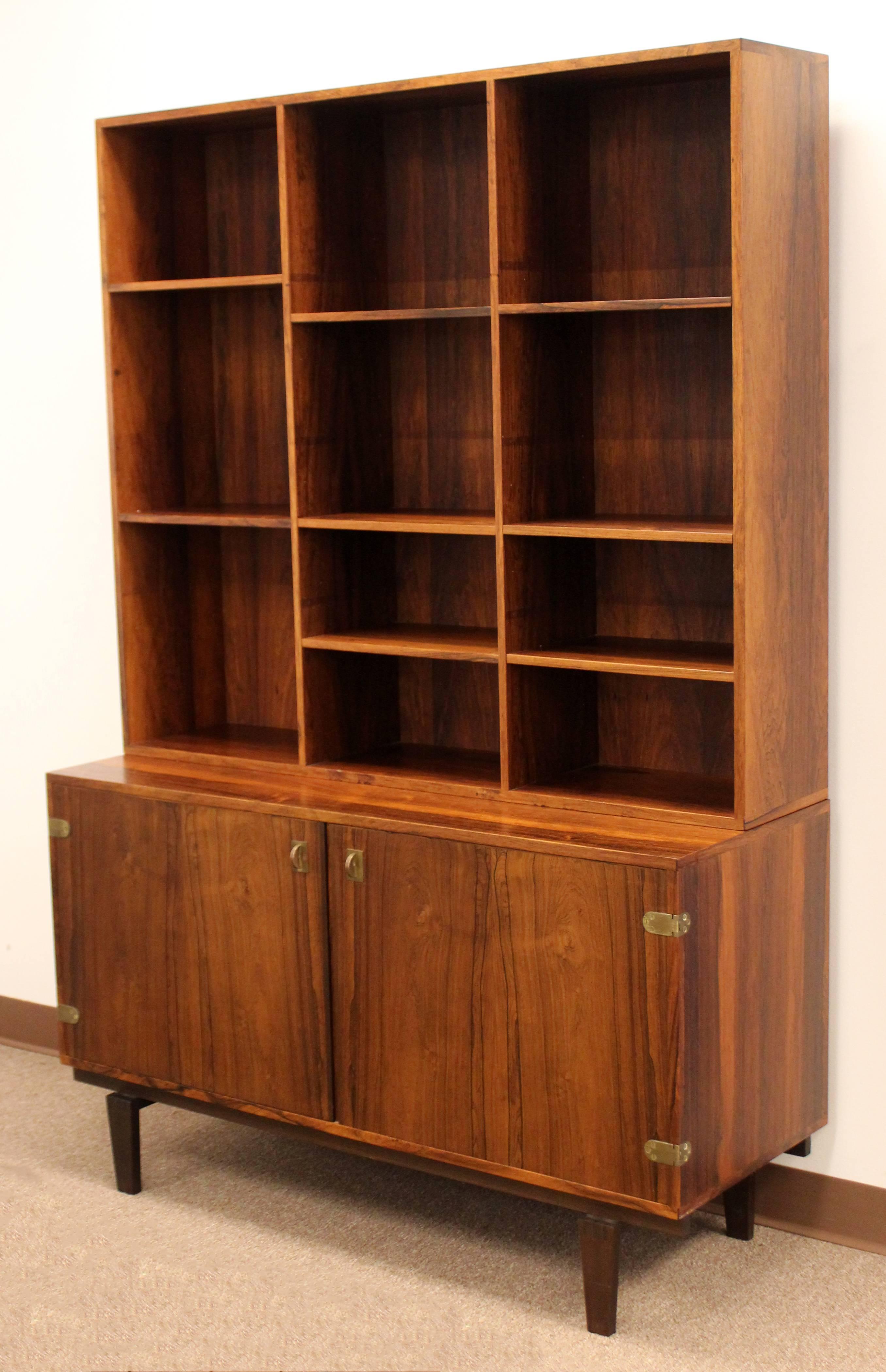 For your consideration is a marvelous, rosewood and brass, bookcase credenza by Peter Lovig for Danish furniture company Hedensted Mobelfabrik, circa 1960s. Matching secretary credenza available in separate listing. Bookcase is in excellent