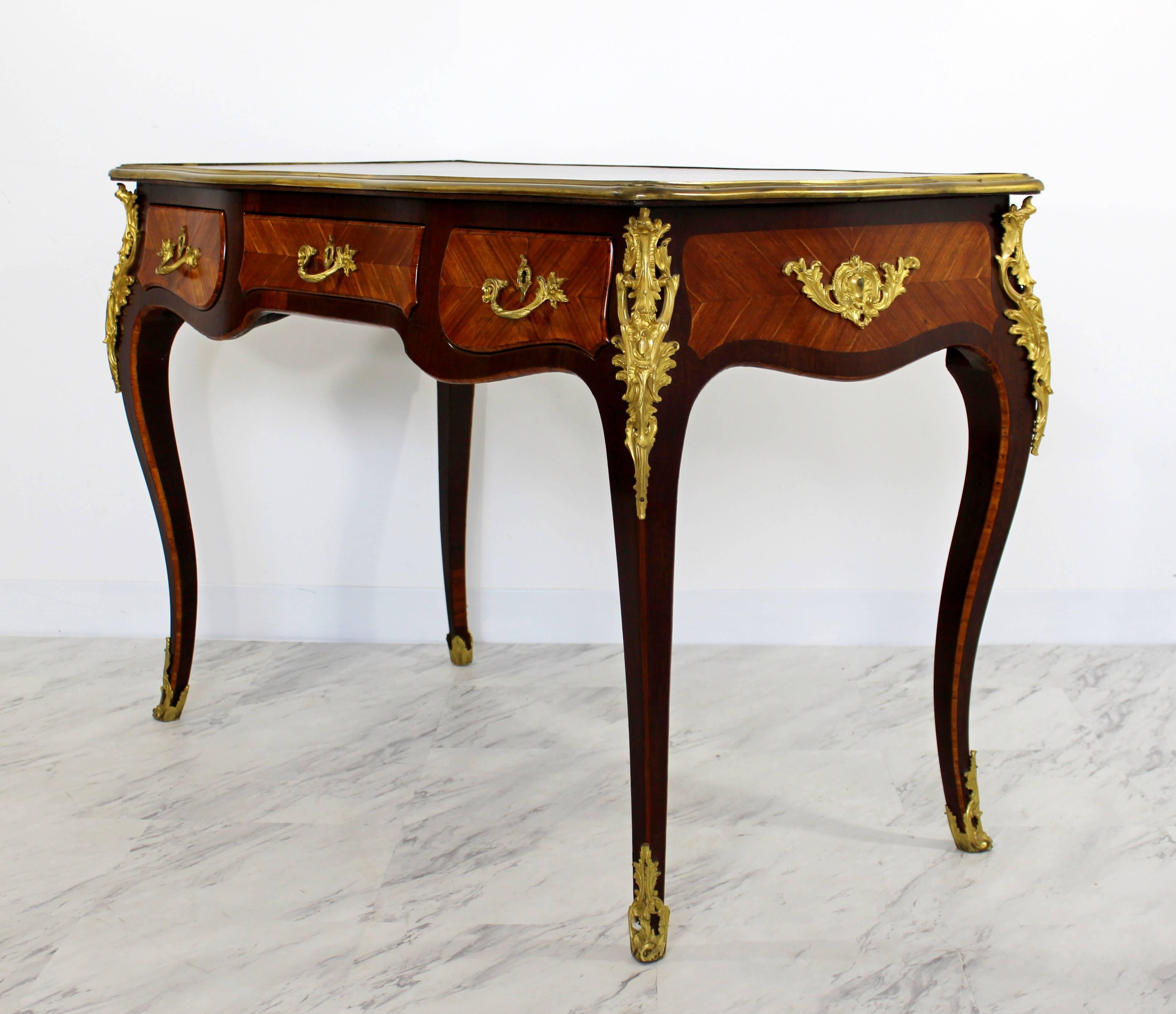 For your consideration is a magnificent, 20th century writing desk, made of mahogany with bronze ormolu. In excellent condition. The dimensions are 46" W x 24" (2') D x 30" H.