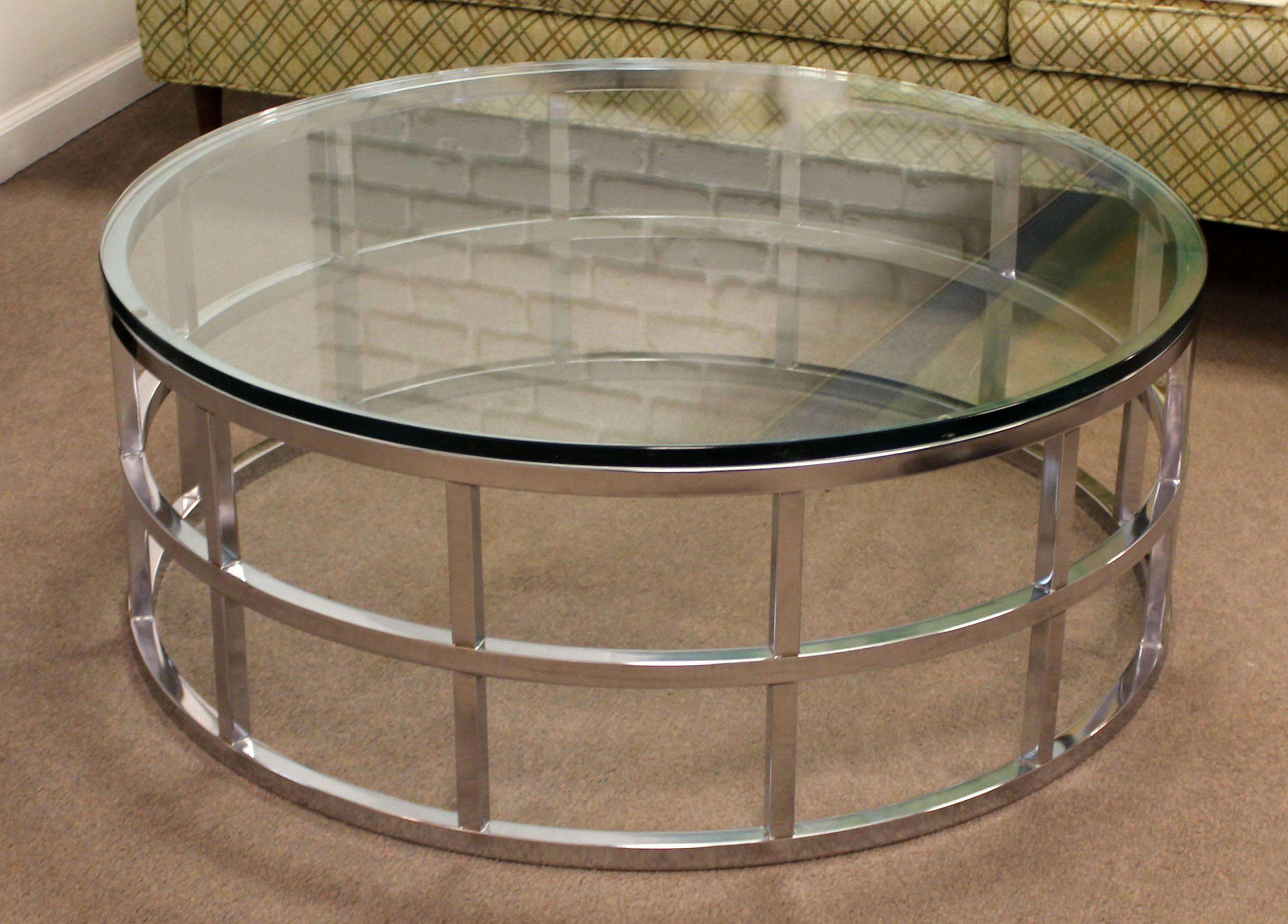 For your consideration is a simple and stunning, chrome and glass, circular coffee table, style of Milo Baughman for the Design Institute of America, circa the 1970s. In excellent condition. The dimensions are 42" Sq x 16" H.