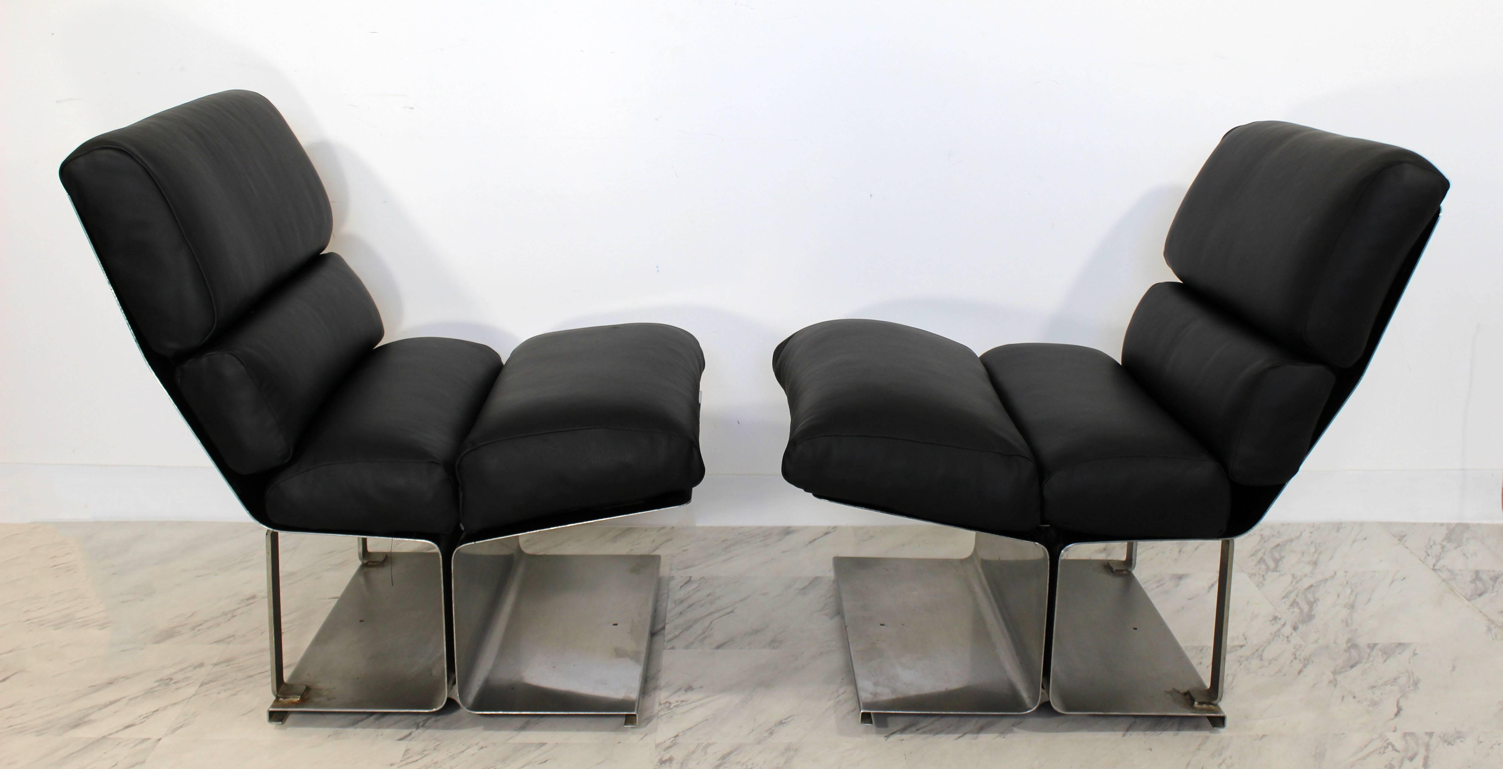 For your consideration is a magnificent pair of steel and black leather hide lounge chairs, by Paul Geoffroy by Uginox, France in the 1970s. Just back from being professionally reupholstered in the finest black leather hide. In excellent condition.