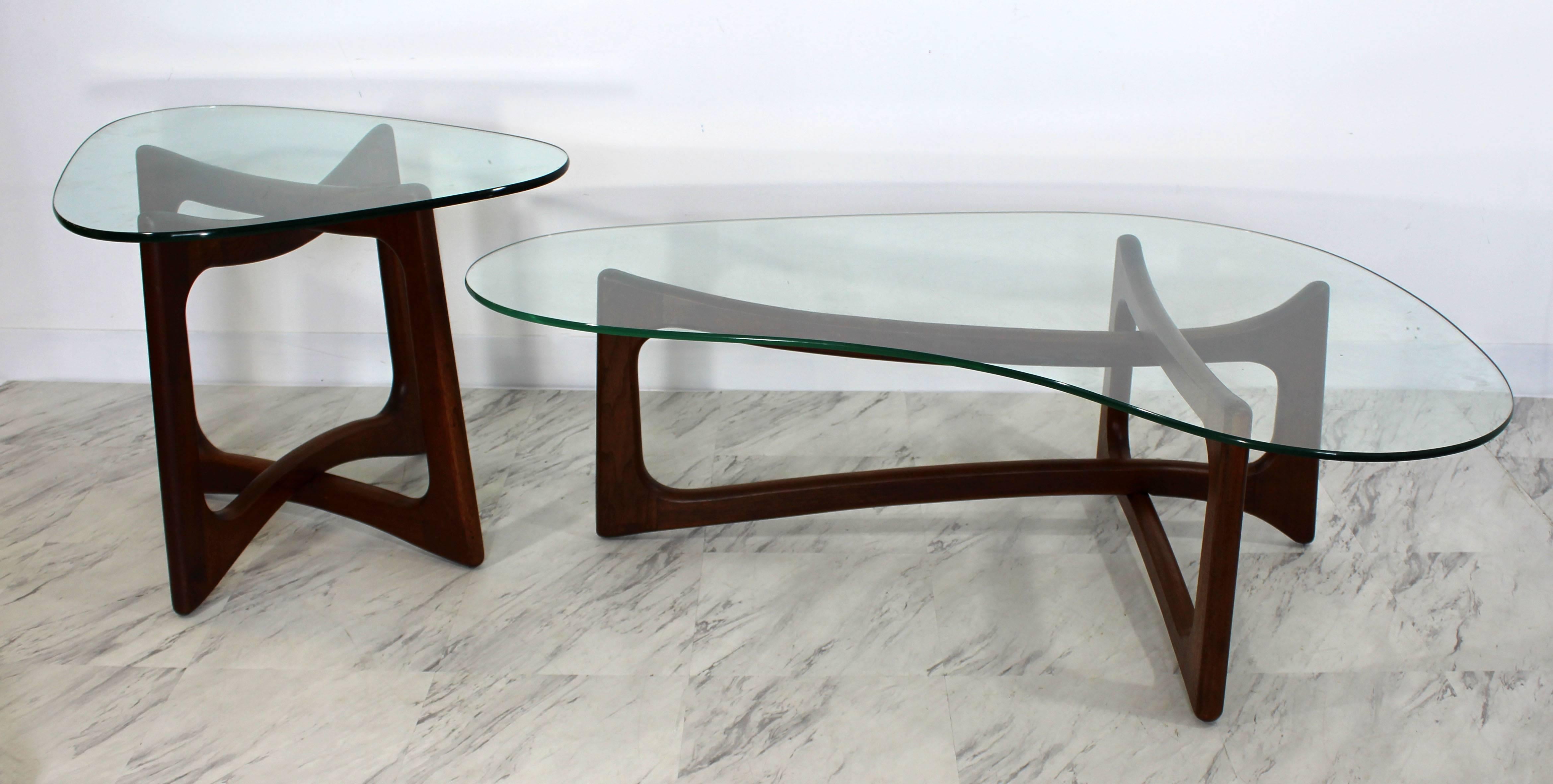 For your consideration is a phenomenal pair of sculptural, walnut and glass, tables, one boomerang kidney coffee table and one interlocking, cube side table, by Adrian Pearsall in the 1960s. In excellent condition, with minor scratching on the