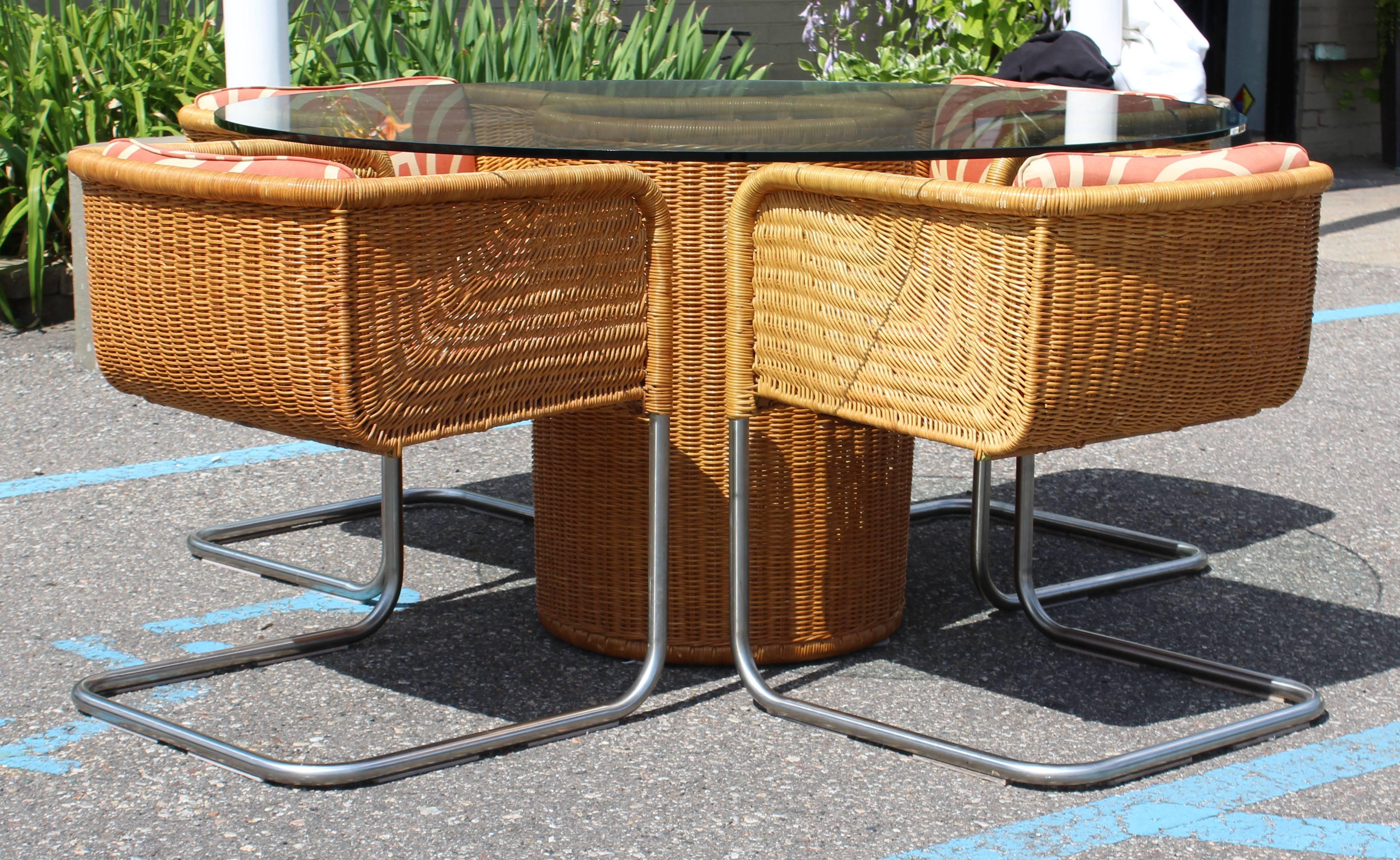 For your consideration is a marvelous, rattan and tubular chrome, patio set by Harvey Probber. This set includes a table with a round, glass top and four cantilever basket chairs. In excellent condition. The dimensions of the table are 54"