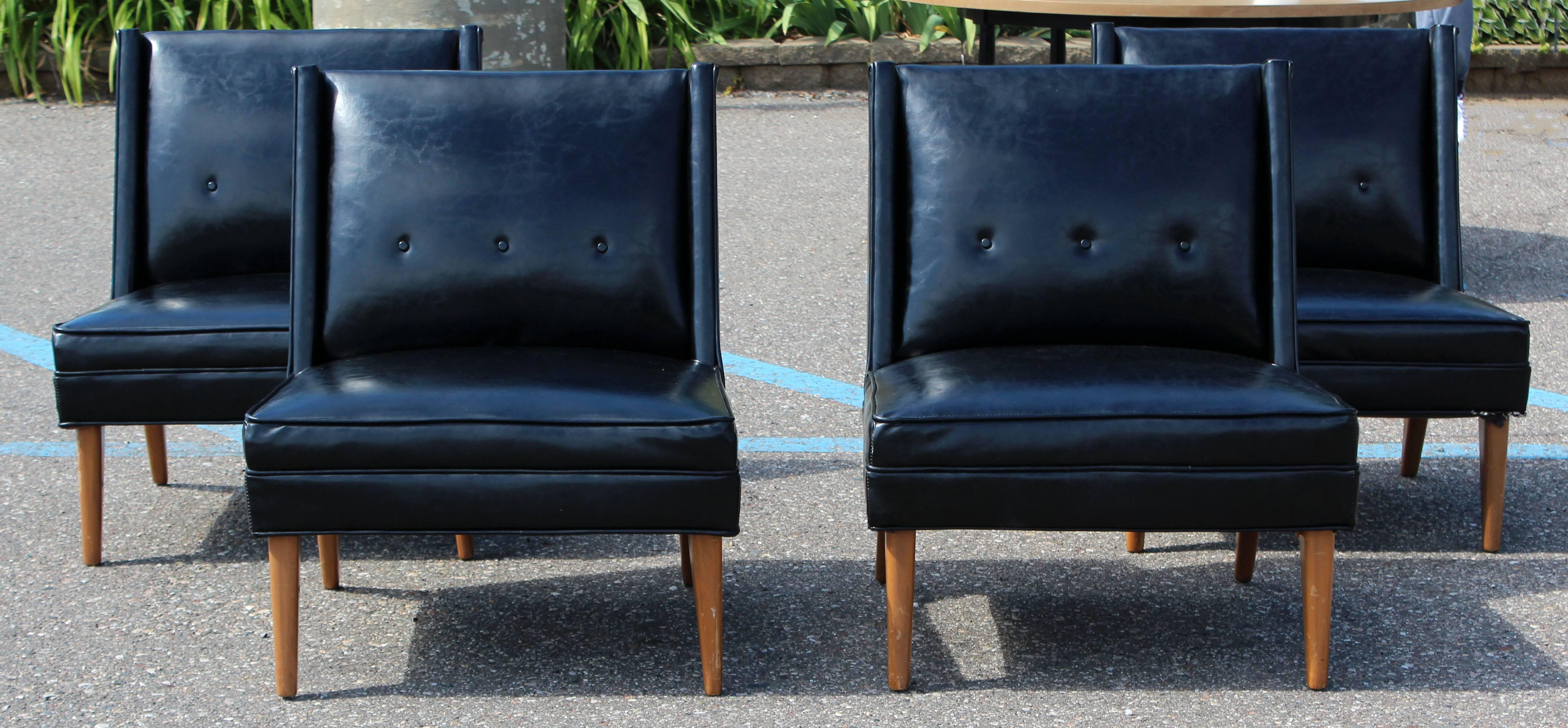 For your consideration is a gorgeous set of four slipper chairs, upholstered in black vinyl, on wooden frames, by Harvey Probber, circa the 1960s. In very good condition. This listing is for two sets of two chairs; we have four total available, and