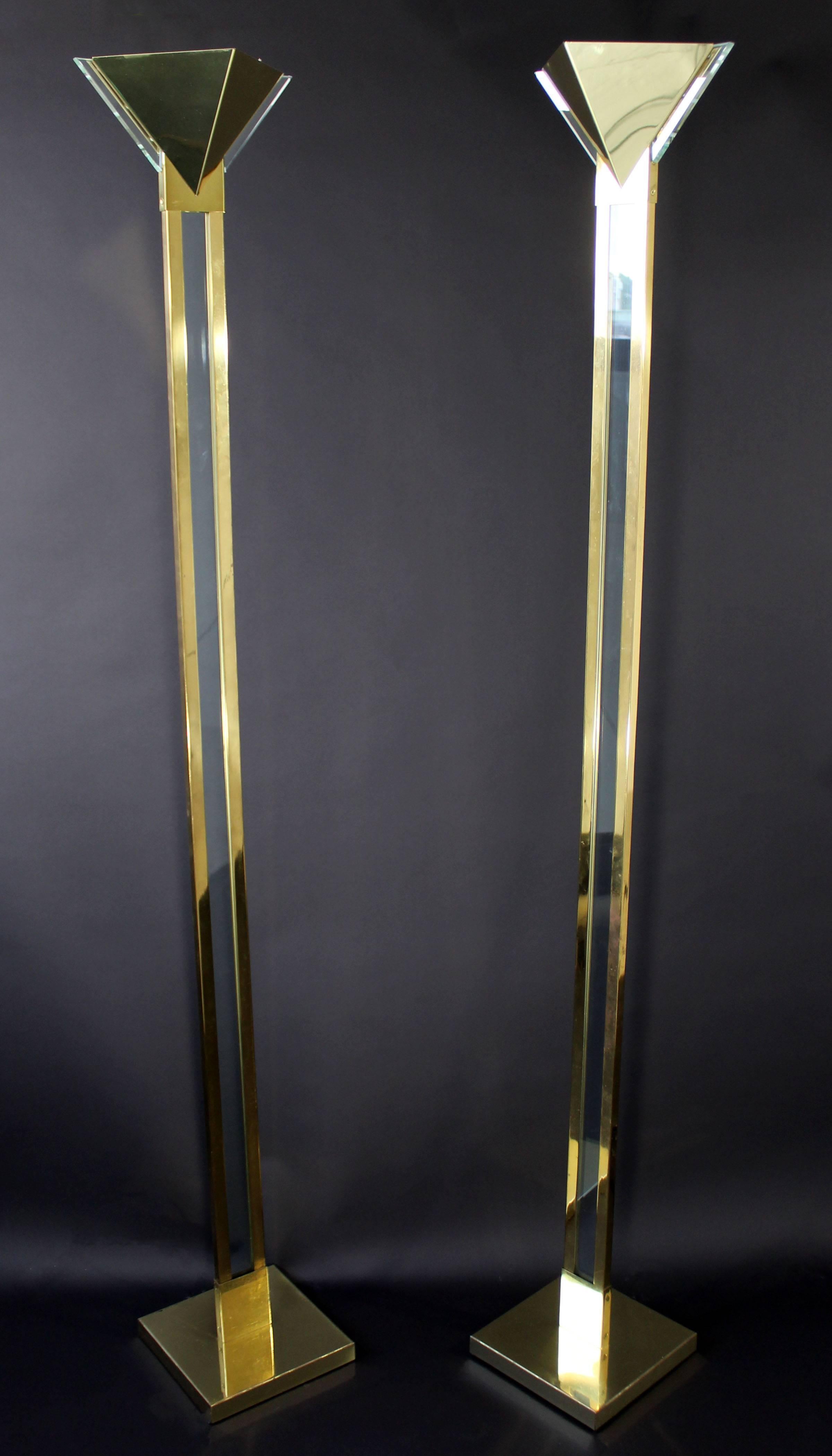 For your consideration is a luxe pair of brass and Lucite floor lamps, designed by Robert Sonneman for George Kovacs, circa 1970s. The Lucite is in mint condition on both lamps, whereas the brass has some wear. The dimensions are 9.5