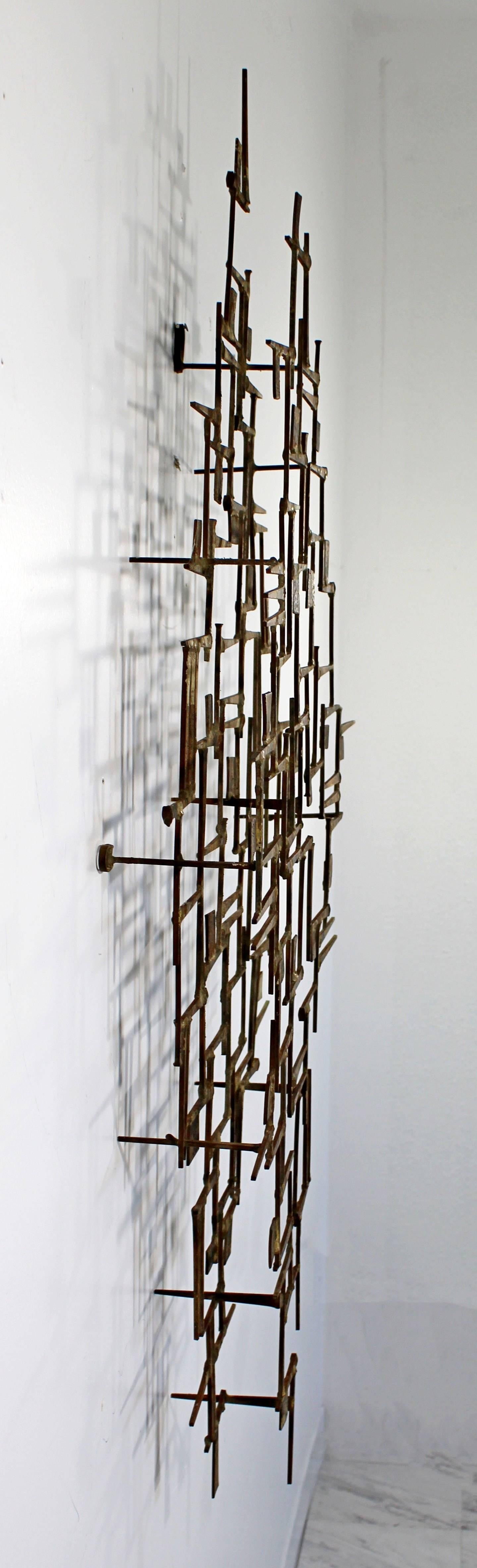 For your consideration is a Brutalist wall sculpture by William Bowie, signed. The spikes of metal are gilded and silvered, and welded together in an intricate, abstract design. Piece can be hung vertically or horizontally. In excellent condition.