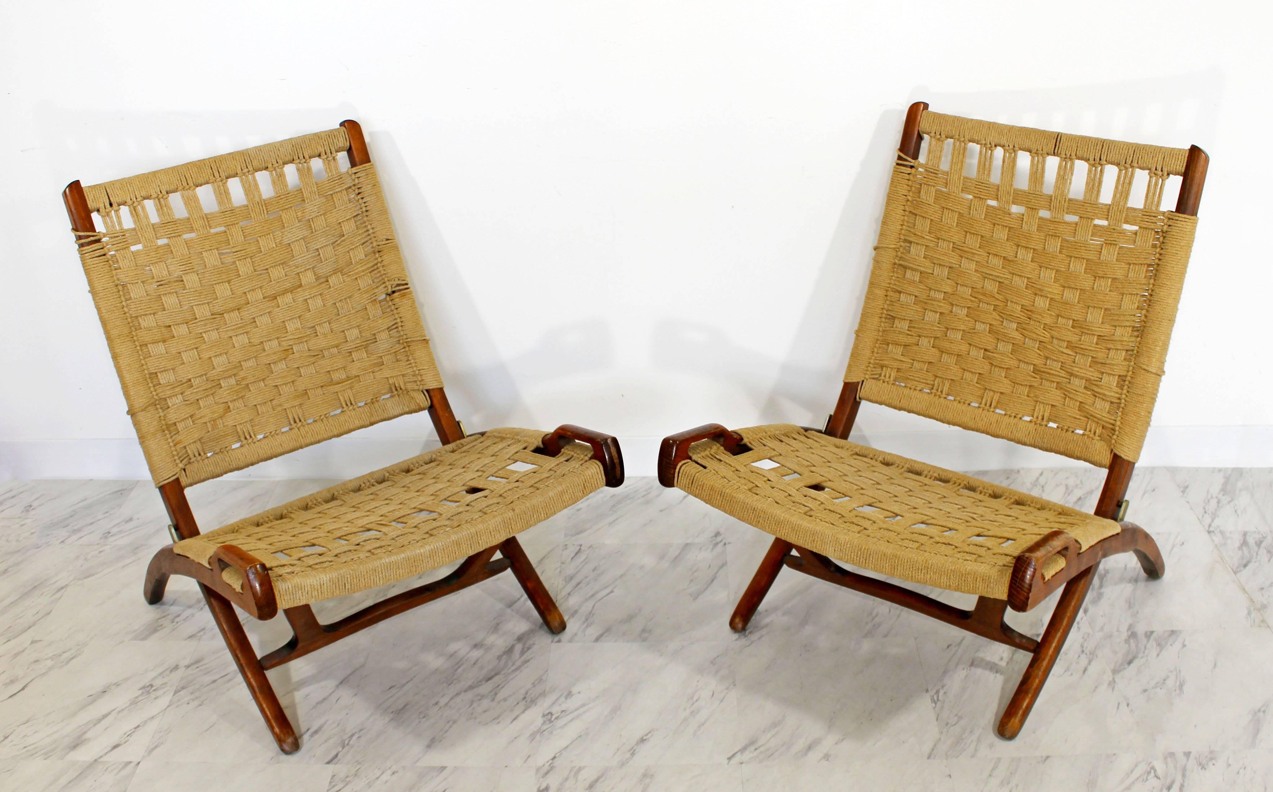 For your consideration is a magnificent pair of low, folding chairs, made of rope cord and wood, in the style of Hans Wegner. Made in Yugoslavia. In excellent condition. The dimensions of the pair are 23.5