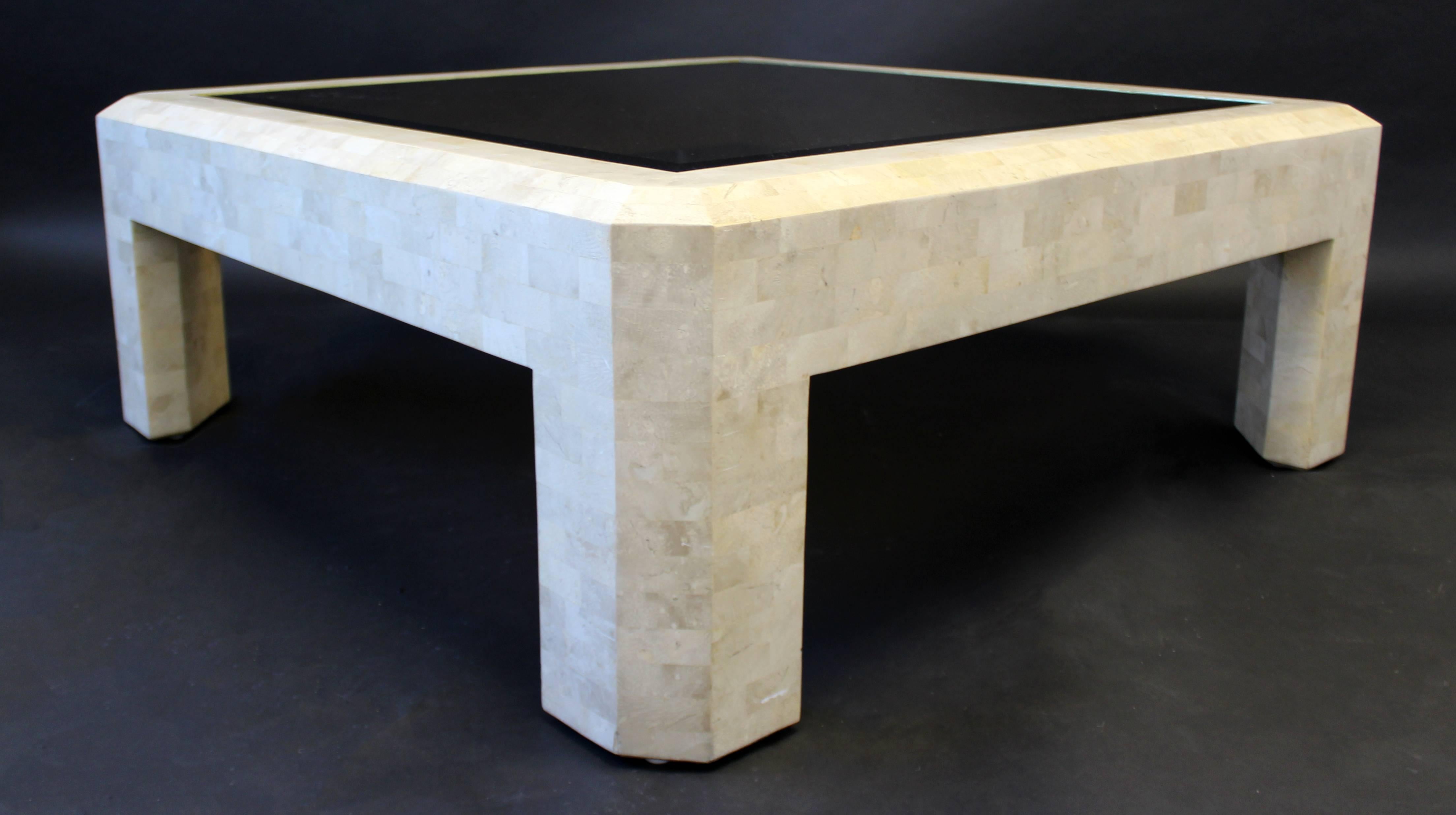 For your consideration is a gorgeous tessellated stone and brass coffee table, with a smoked glass top, by Maitland Smith. In excellent condition. The dimensions are 40