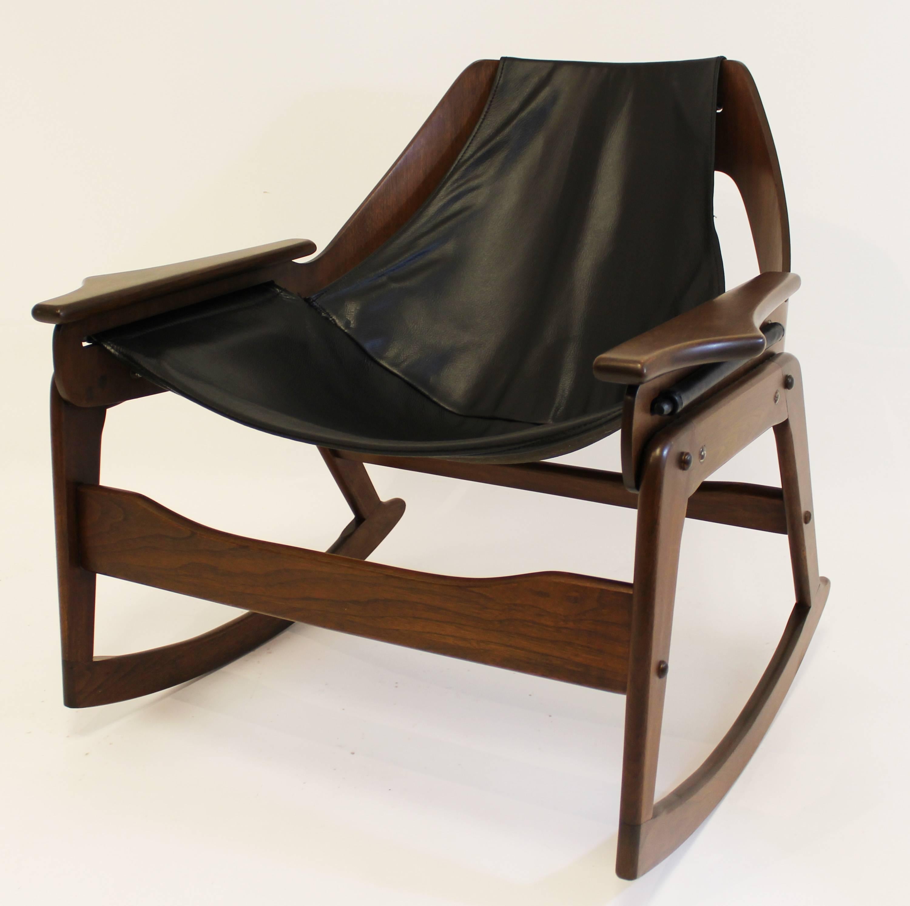 For your consideration is a stunning sling rocker by Leathercrafter made of dark walnut and leather, circa 1960s. In excellent condition. Professionally refinished. The dimensions are 30.25